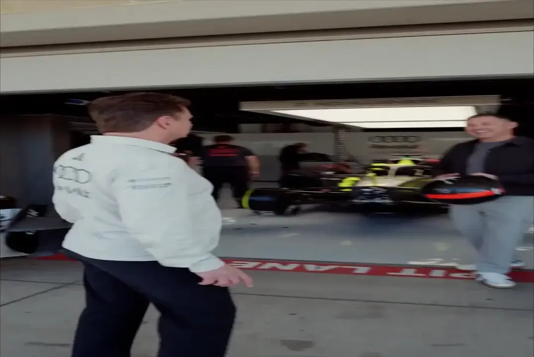 Audi Revolut F1® Team Racing Director Allan McNish and Audi Sport Ambassador Tom Kristensen joking and talking in front of the garage.