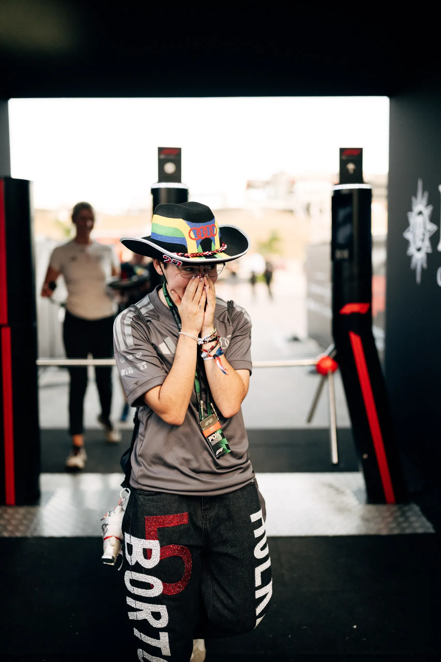 Emotional fan in a cowboy hat covering their face in the Audi Revolut F1® Team paddock at the USA Grand Prix