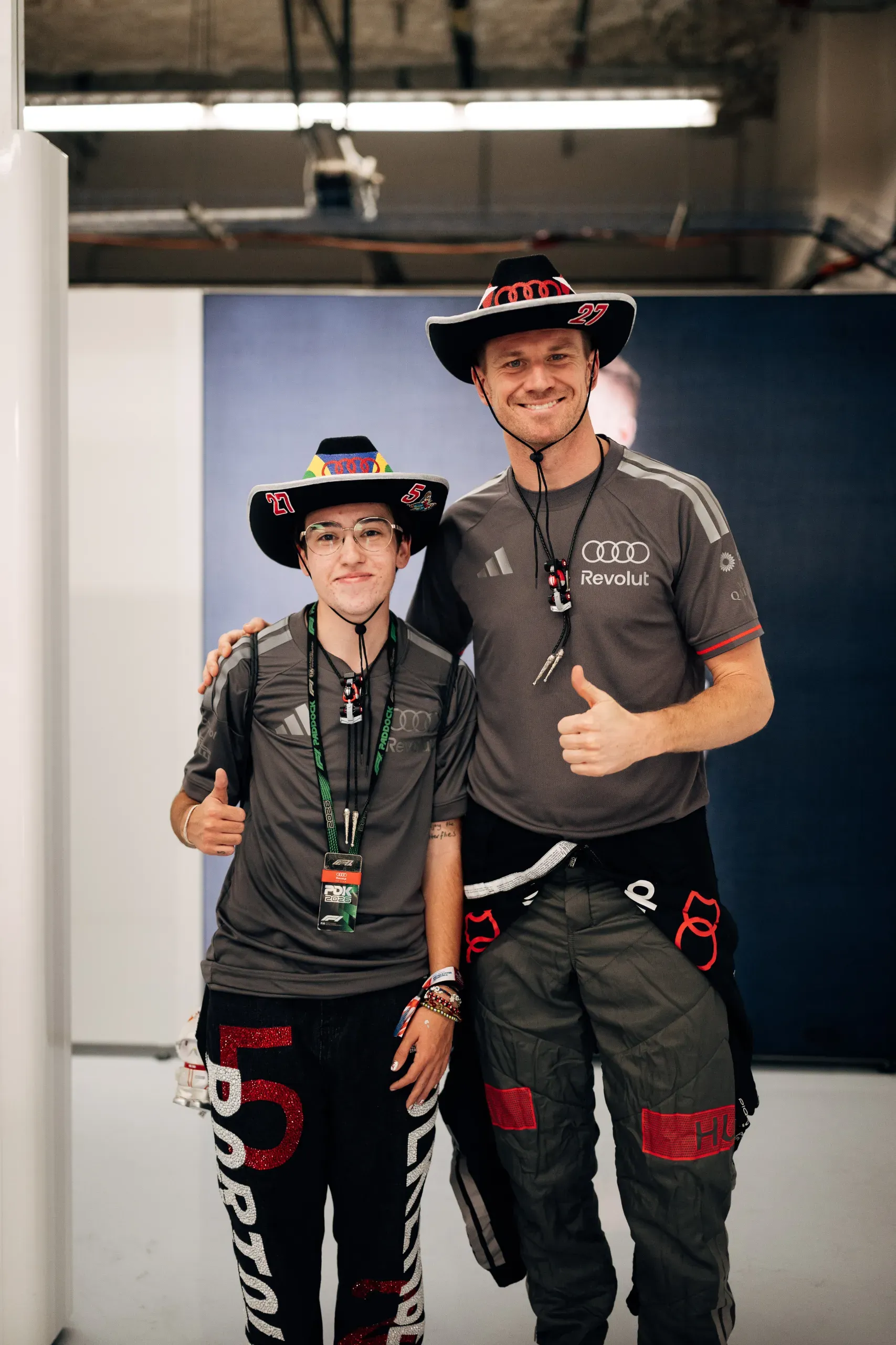 Audi Revolut F1® Team driver Nico Hulkenberg posing with a fan in matching cowboy hats at the USA Grand Prix