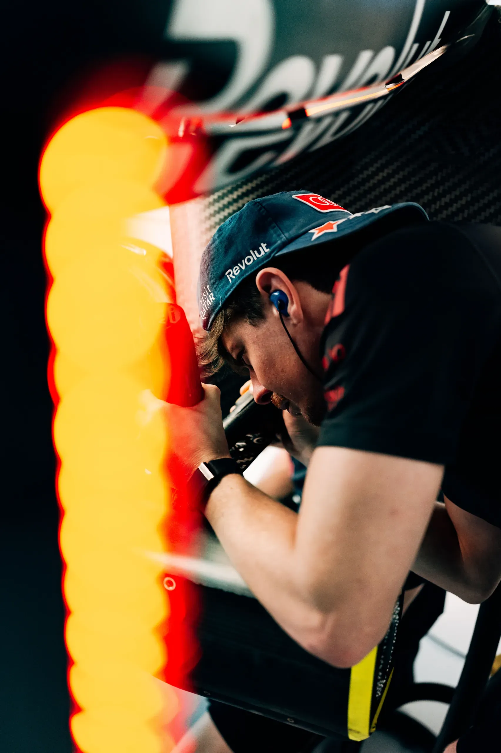 A mechanic of the Audi Revolut F1® Team leaning in to work on the Audi R26 in the garage at the USA Grand Prix