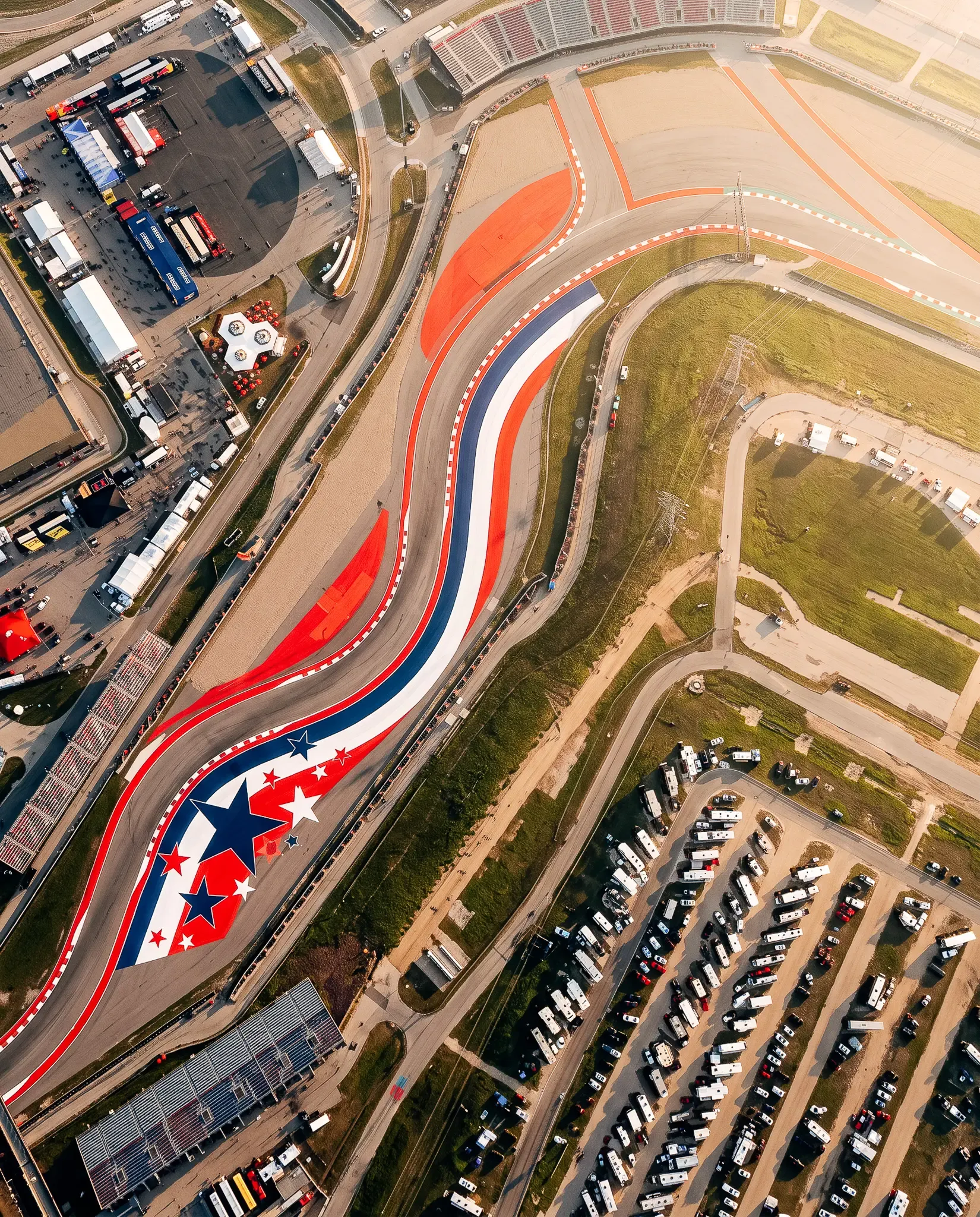 Circuit of The Americas track layout with red, white and blue racing graphics, aerial view.
