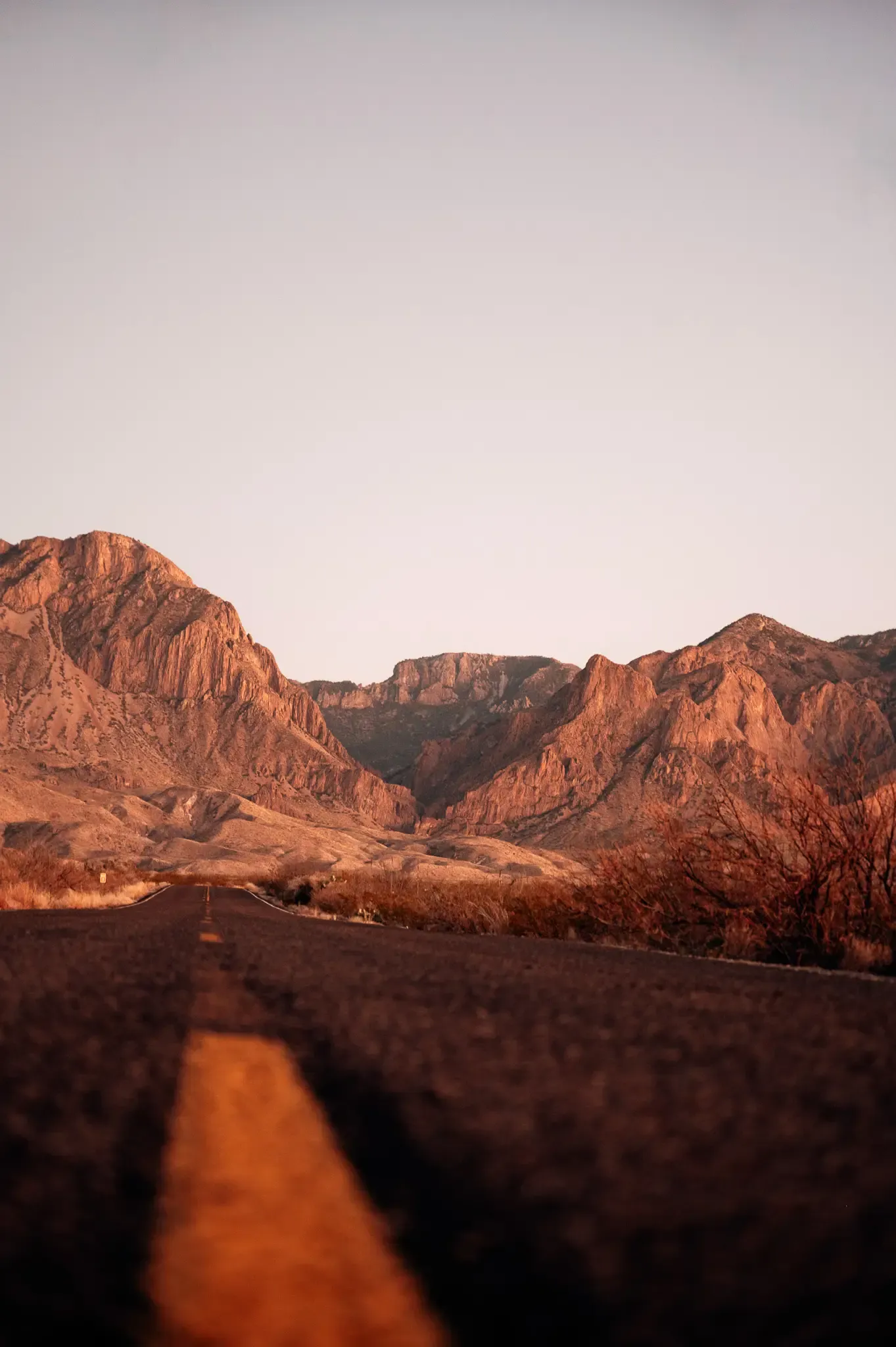 Team rugged Texas desert mountains in warm evening light.