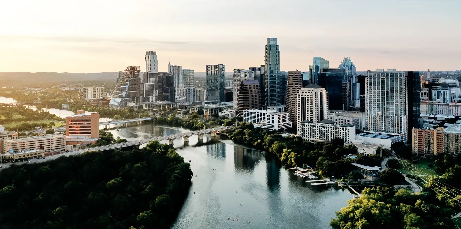 Aerial view of the Austin skyline and Colorado River in daylight.