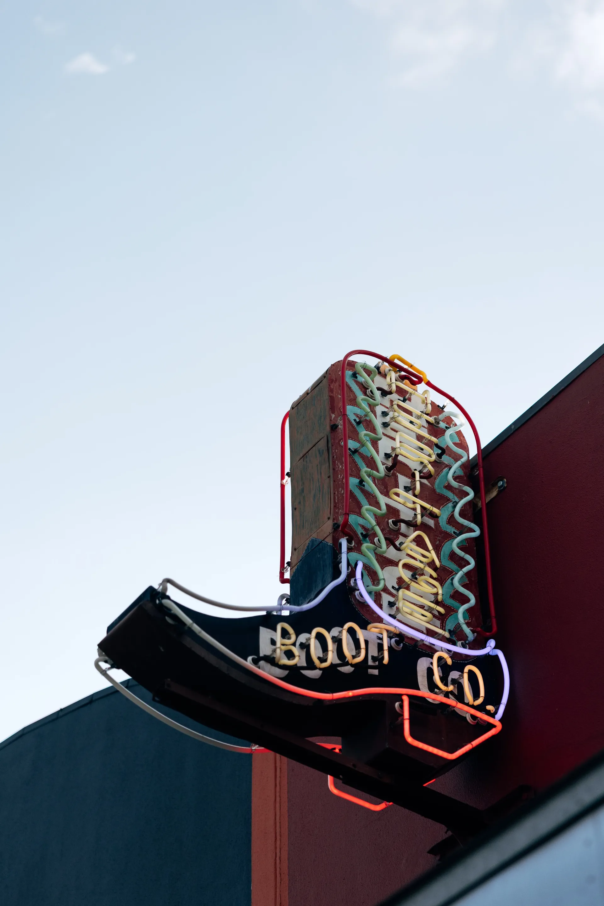 Neon cowboy boot sign of a boot company against the sky in Austin, United States Grand Prix