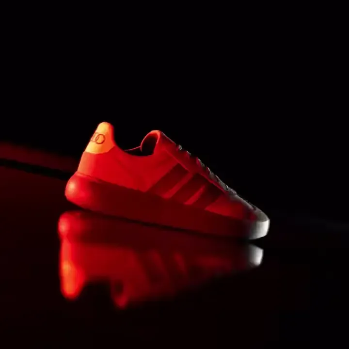 Close up of the adidas x Audi Revolut F1® Team fanwear collection BARREDA DECODE shoes in dramatic red light in the Studio