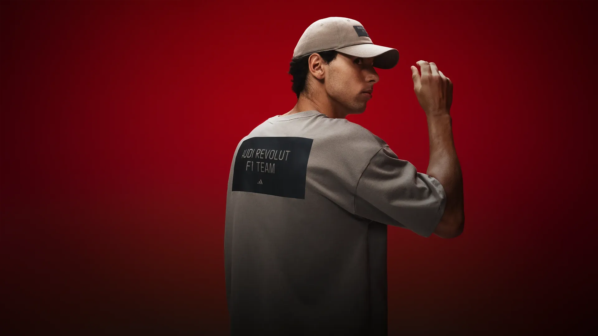 Backshot of Gabriel Bortoleto wearing adidas x Audi Revolut F1® Team Fanwear collection graphic tee in the studio