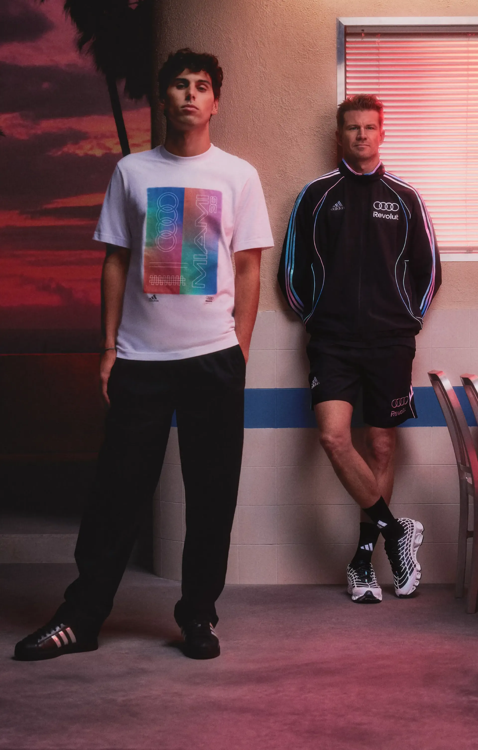 Nico Hulkenberg and Gabriel Bortoleto, athletes of the Audi Revolut F1® Teamstanding side by side in studio wearing fanwear outfit