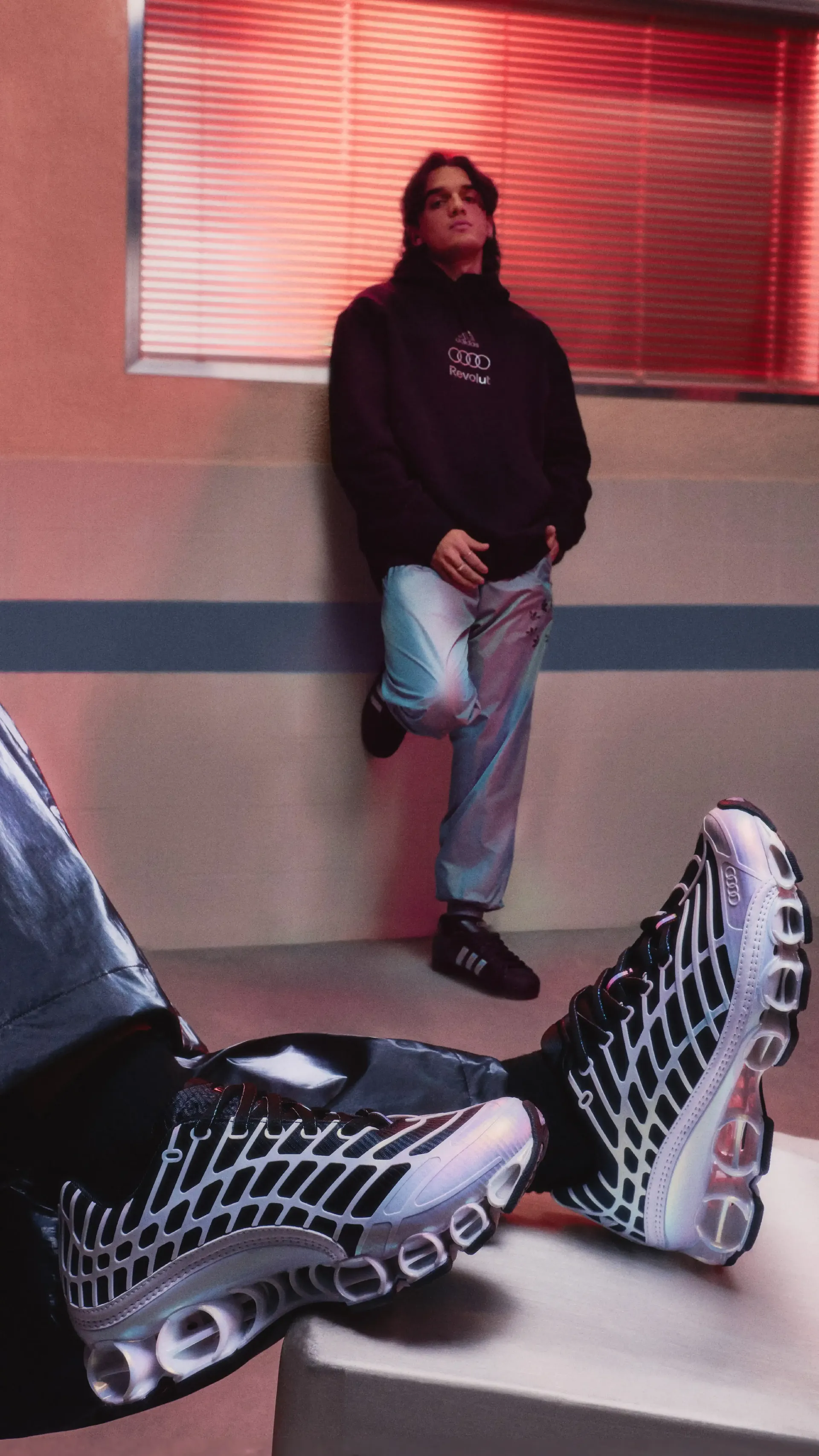 Close-up of adidas fanwear sneakers on feet with casual outfit styling