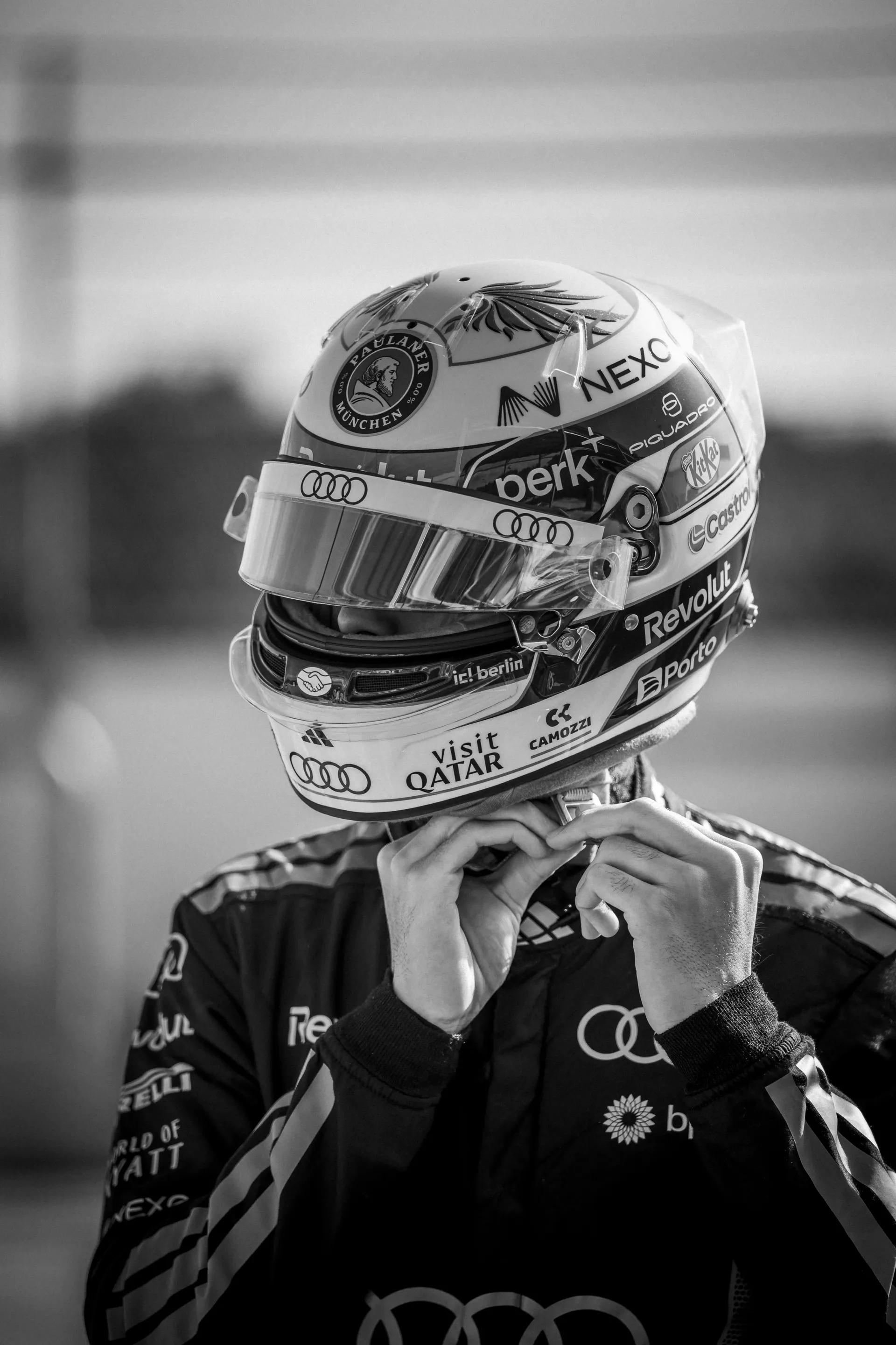 Audi Revolut F1® Team driver Gabriel Bortoleto adjusting his racing helmet before testing the Audi Nuvolari.