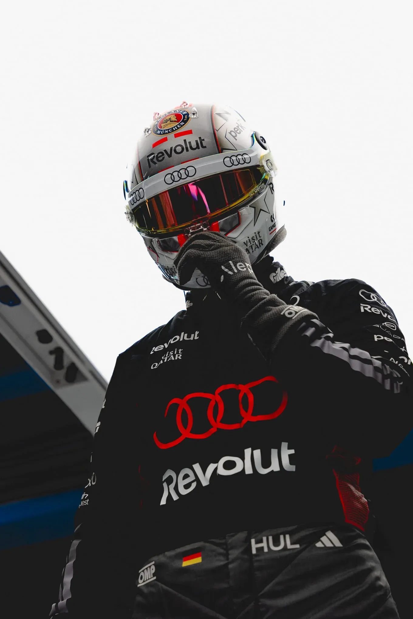 Low-angle shot of Nico Hulkenberg in his helmet and race suit, Audi Revolut F1® Team