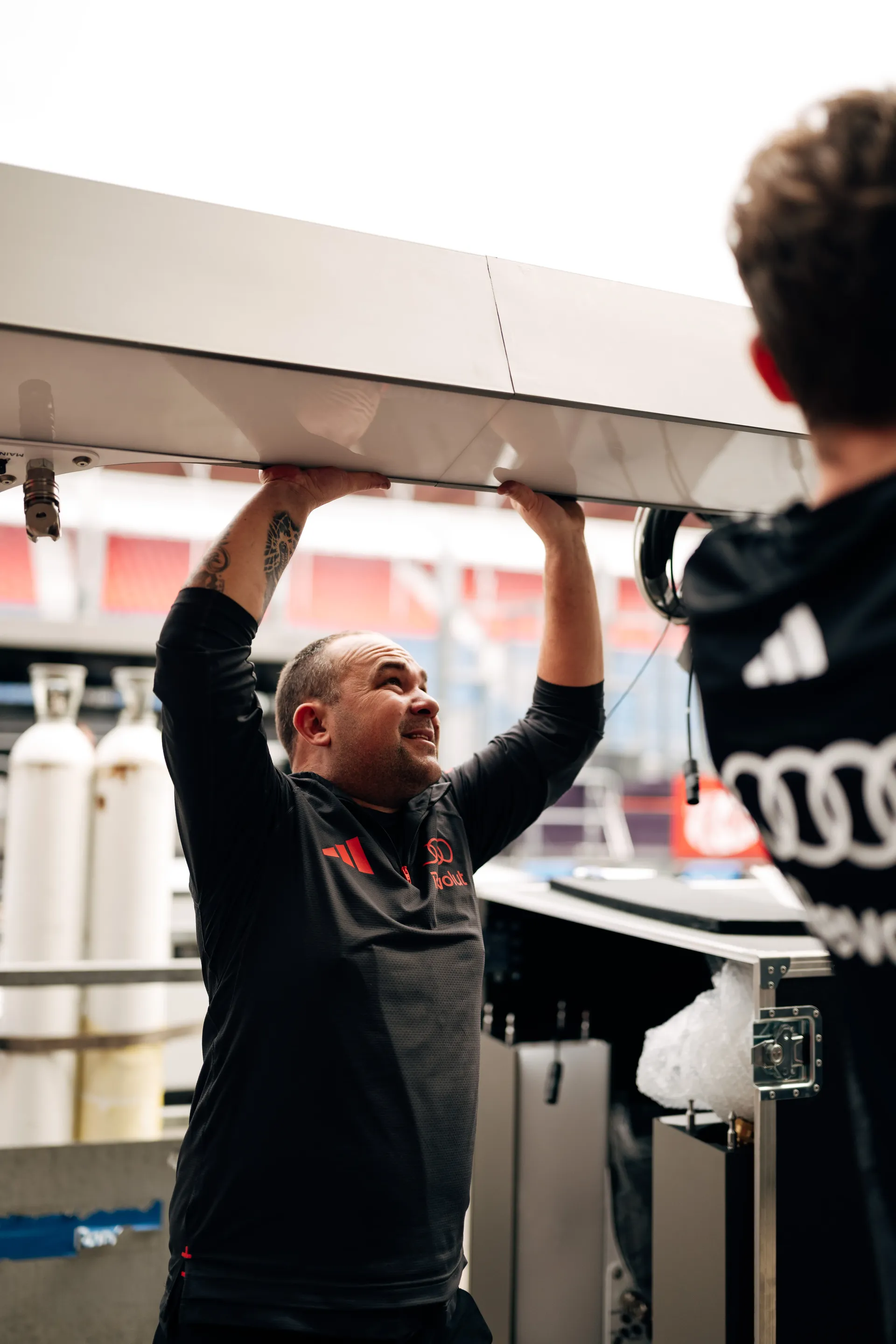 A team member setting up the pit holding a massive piece of the interior