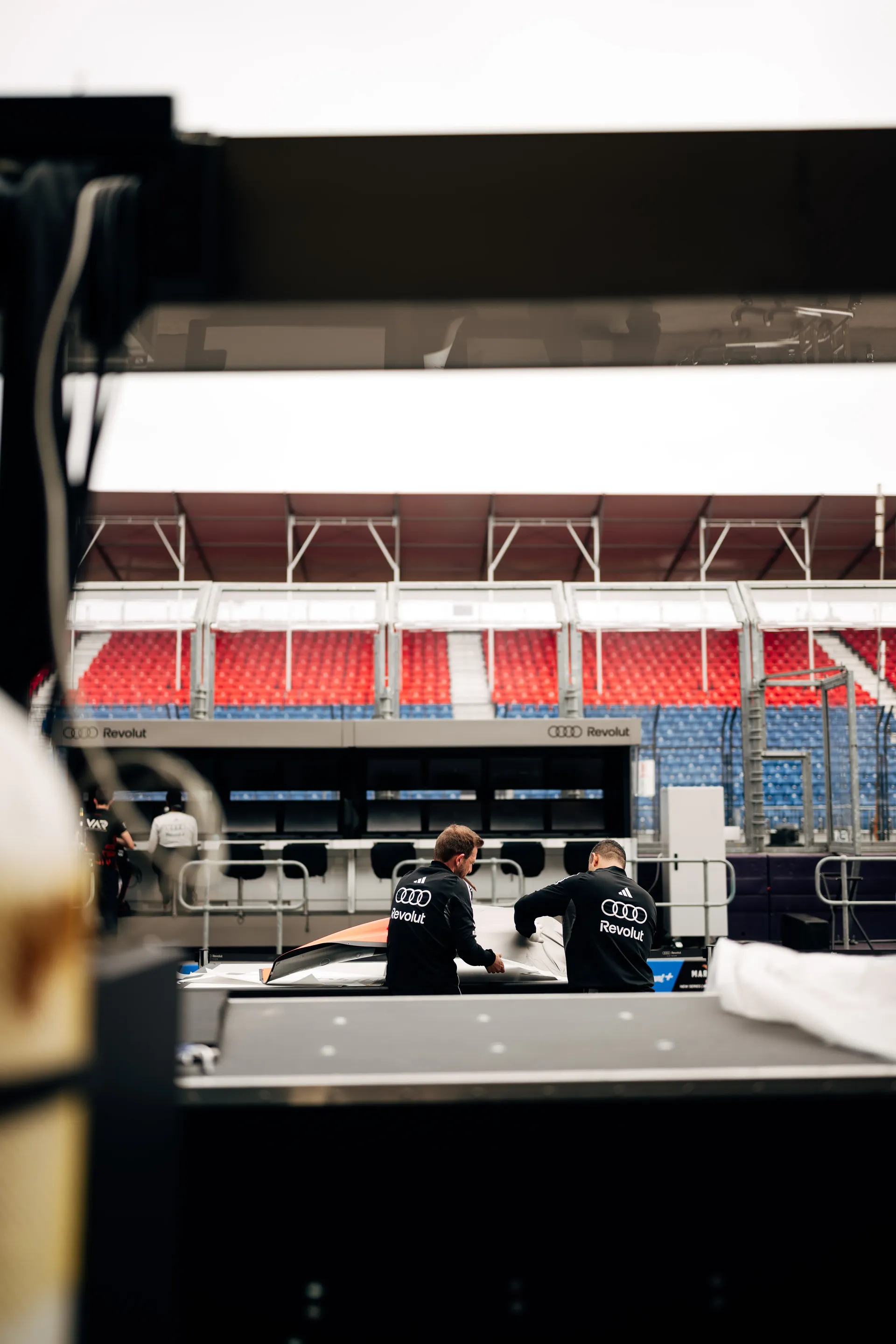 View from the inside of the box through the pitwall where team members are working 