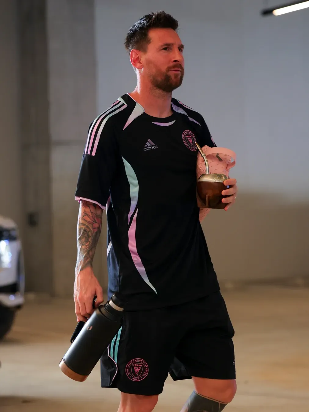 Messi wearing adidas x Audi Revolut F1®Team driver Jersey inside the soccer lockerroom