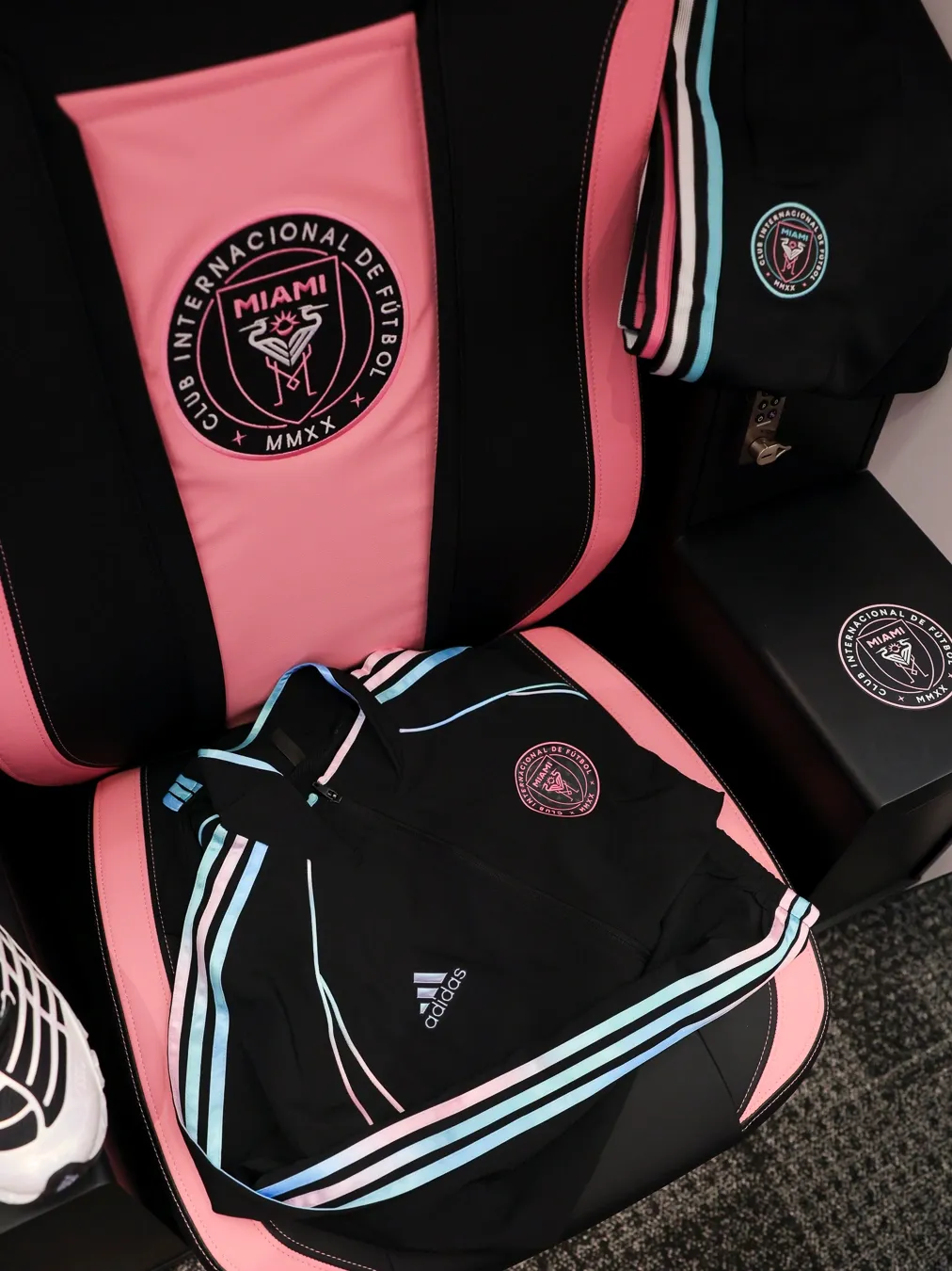A detailed shot of Inter Miami CF players in the locker room showing their full adidas kit, with adidas, Audi, and the Revolut F1® Team branding prominently featured.