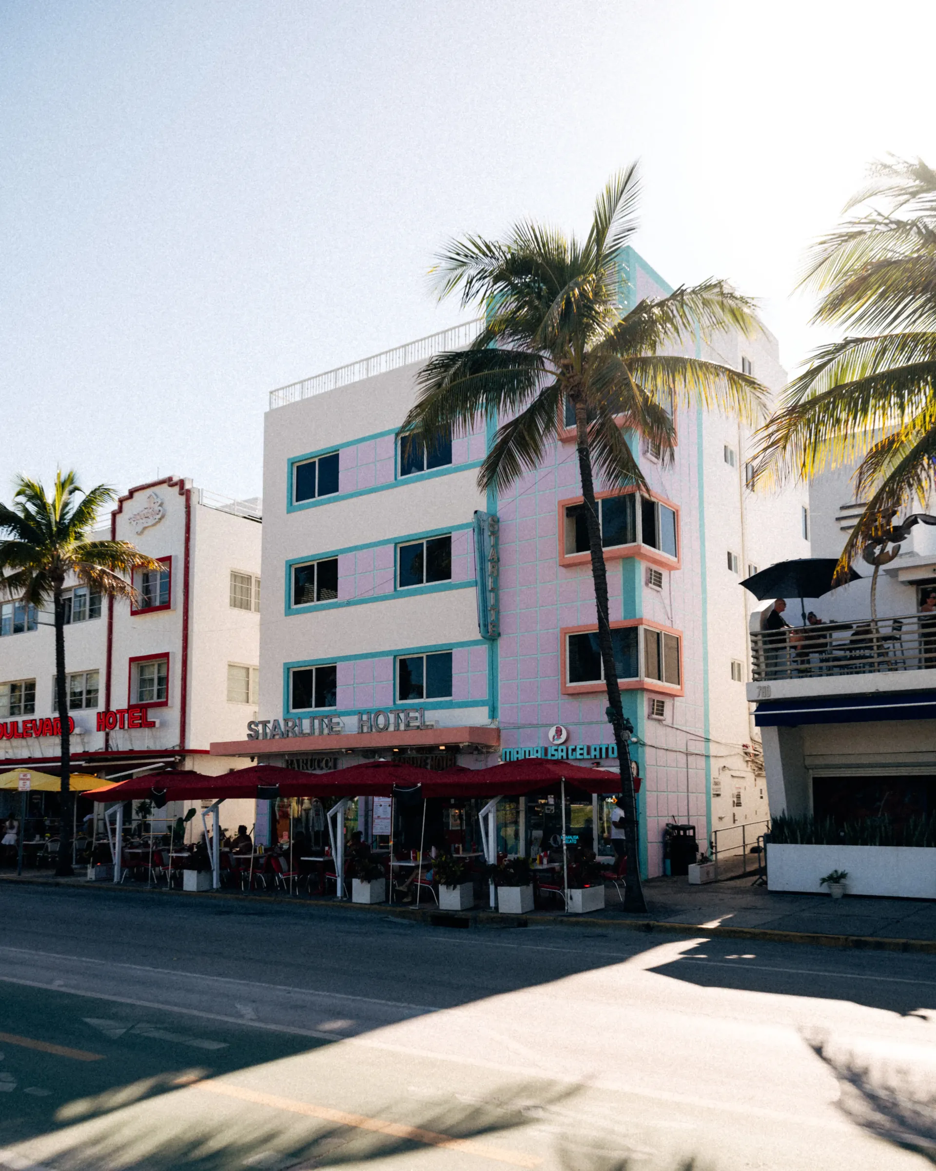 Colorful Miami Beach shopping street with palm trees and storefronts