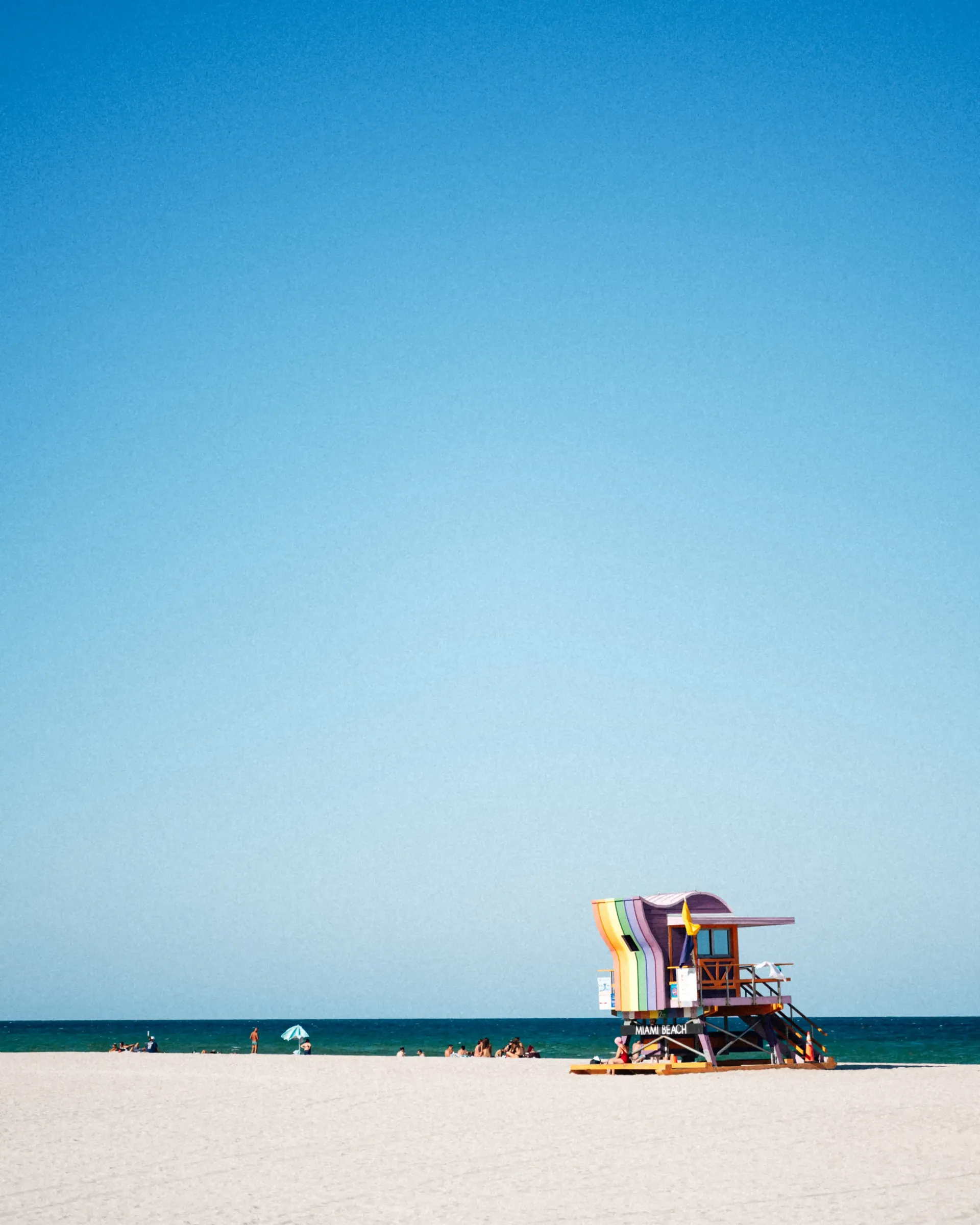 Minimalist Miami beach scene with lifeguard stand and ocean horizon