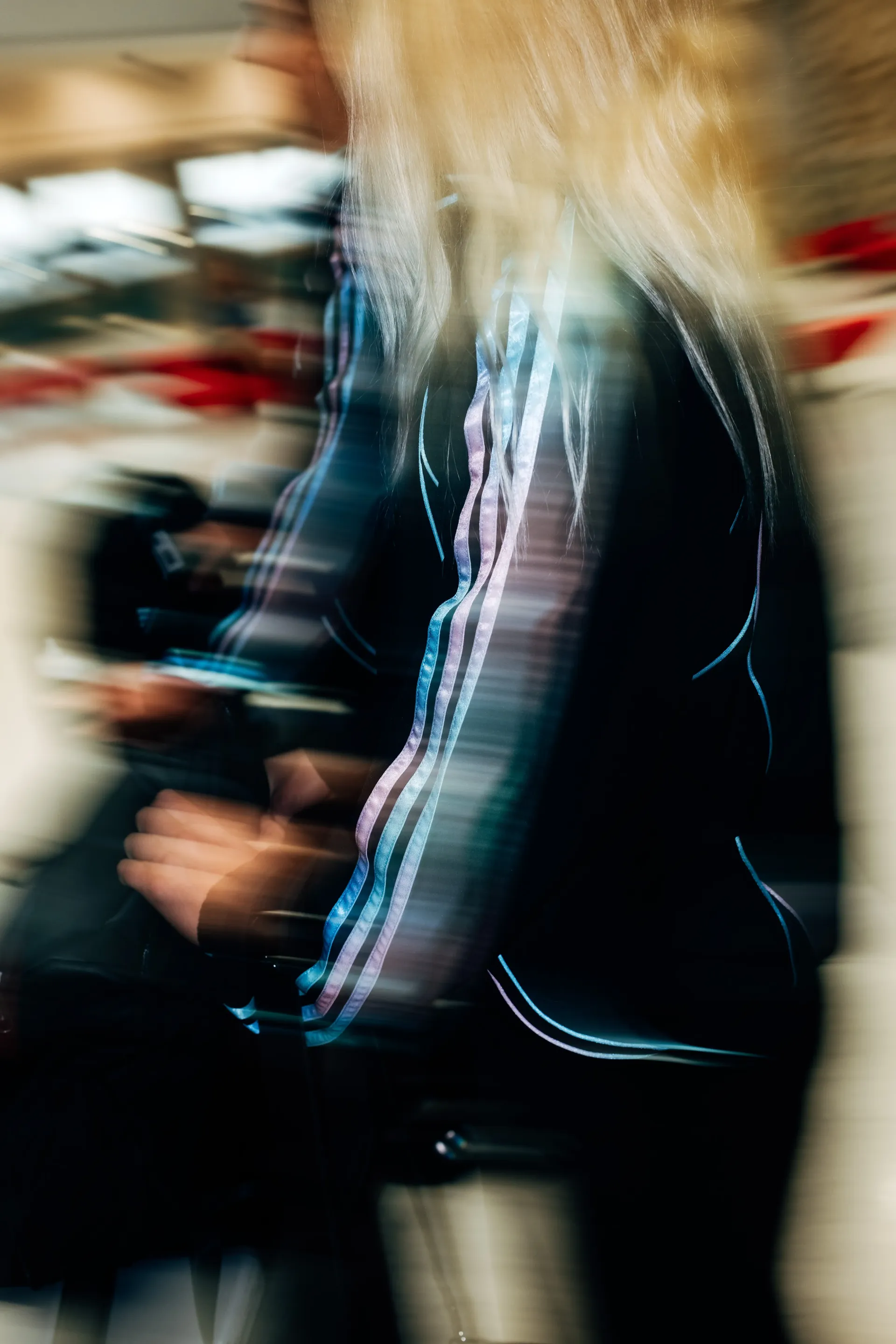 Close-up of  Audi Revolut F1®Team crew walking through terminal corridor in the new Miami collection tracksuit.