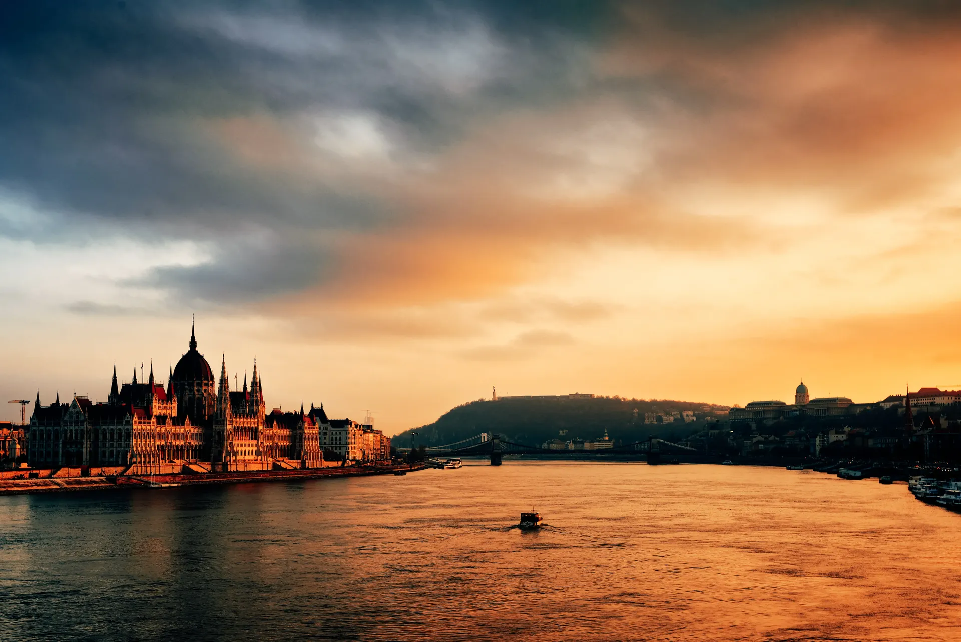 Sunset view across the Danube River with the Hungarian Parliament Building in Budapest.