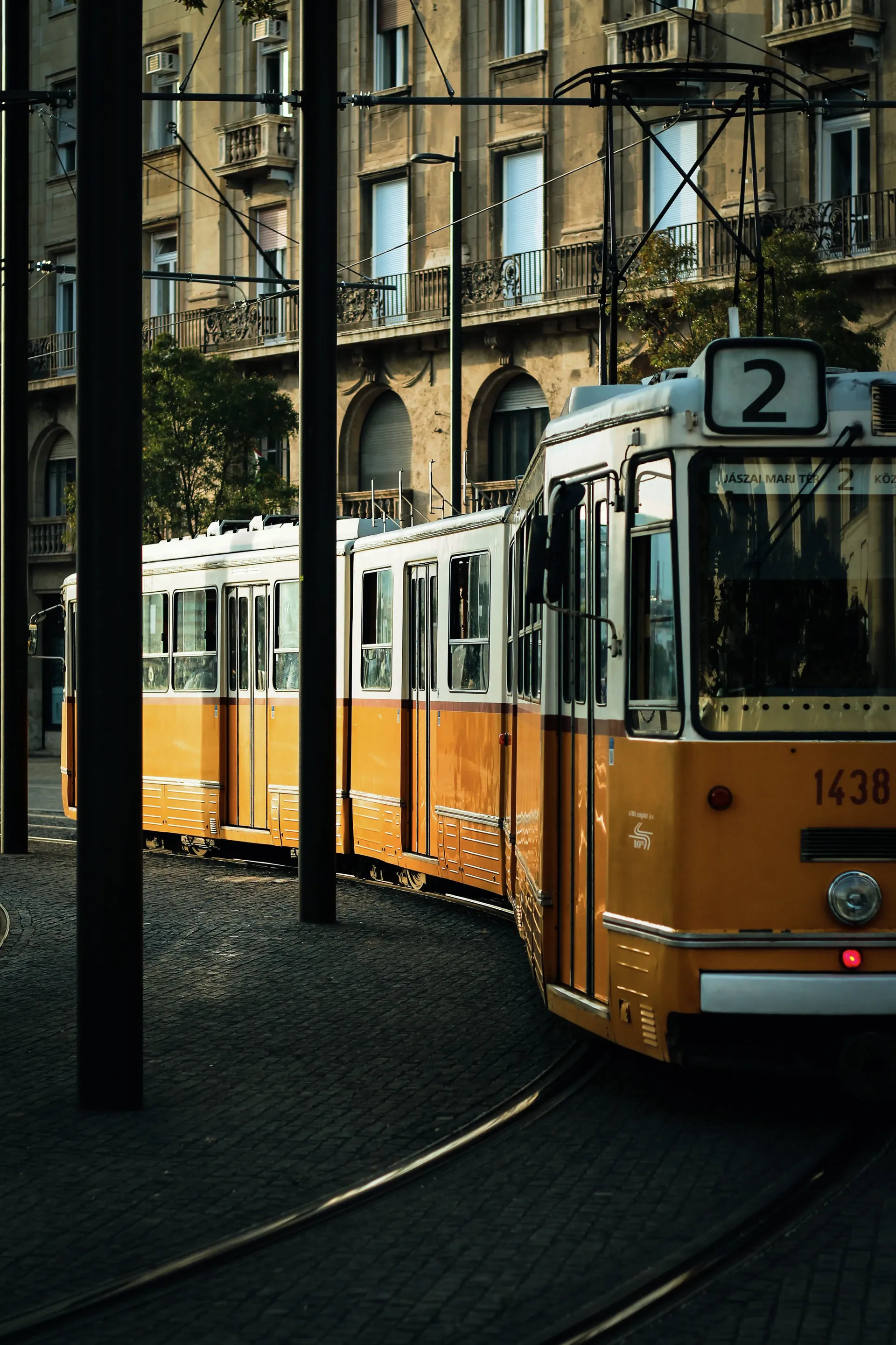 Traditional yellow Budapest tram travelling through the city's historic streets.