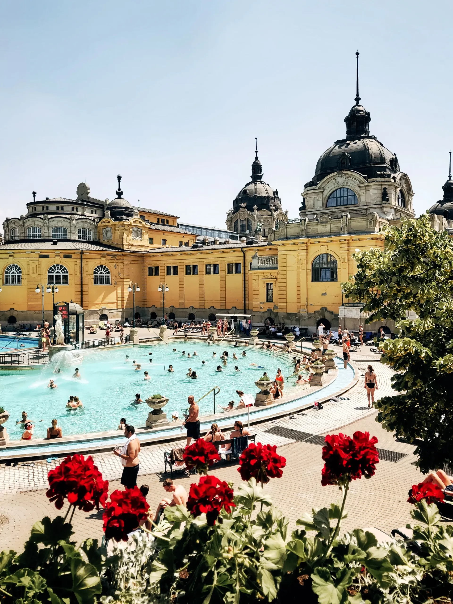 Visitors relaxing in the outdoor thermal pools of Széchenyi Thermal Bath in Budapest.