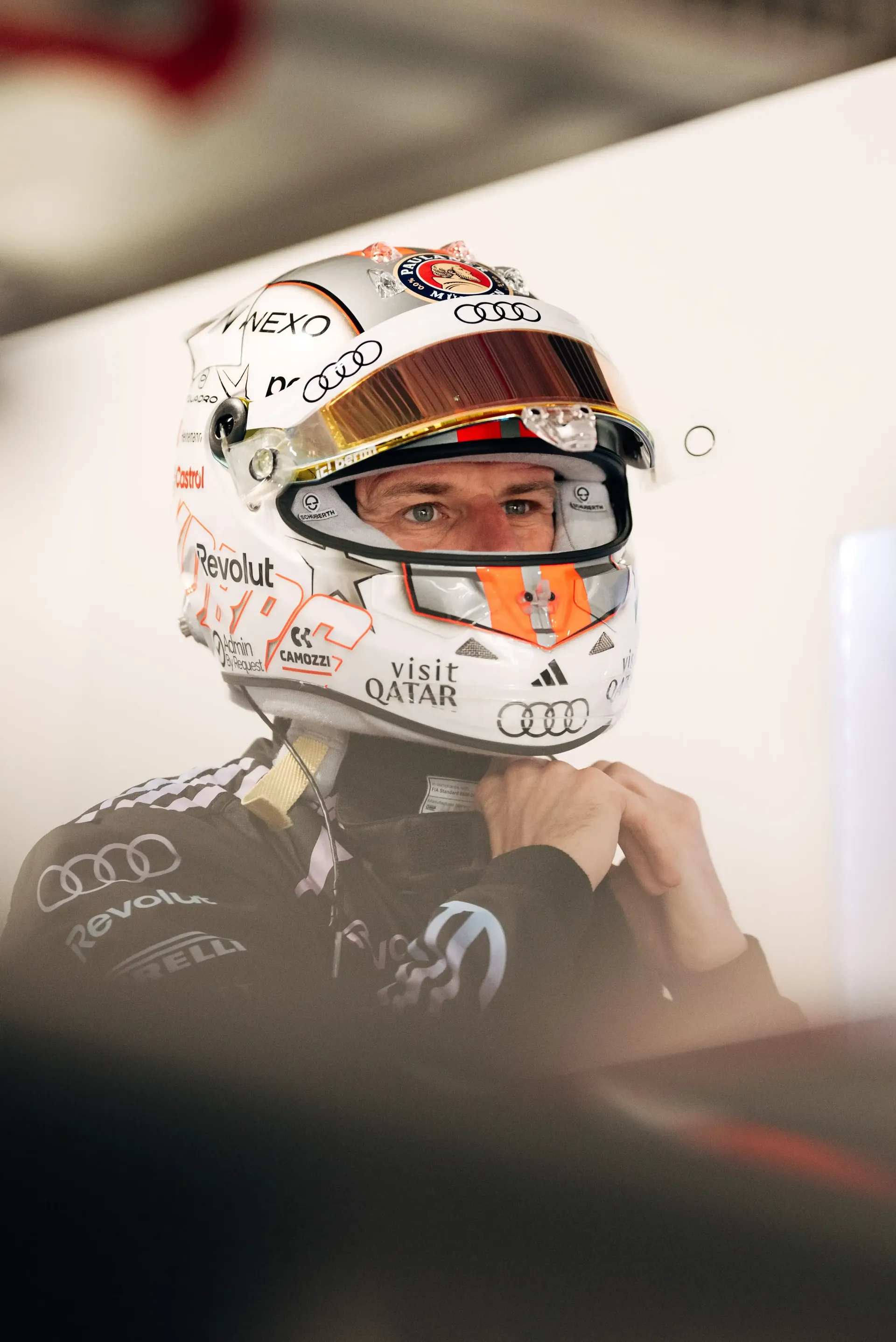 Nico Hulkenberg driver at the Audi Revolut F1® Team puttin on his helmet inside the garage