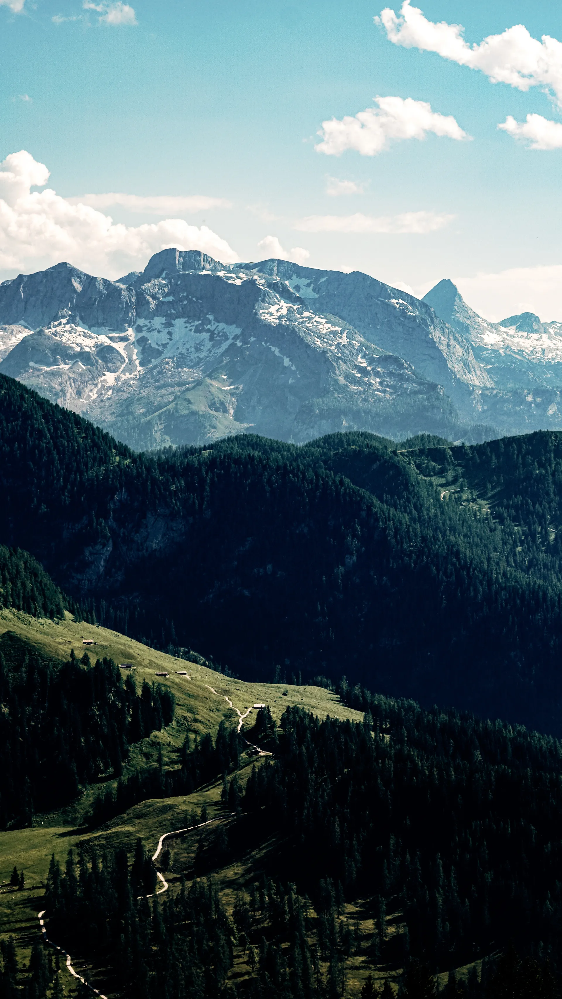 Alpine mountain scenery overlooking rolling green hills near the Red Bull Ring in Austria.