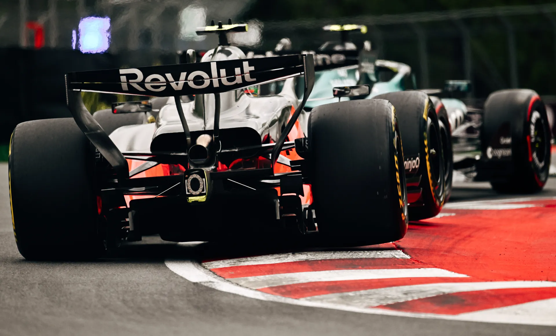 Rear view of Audi Revolut F1® Team car Audi R26 exiting a corner at the Red Bull Ring during a race session.