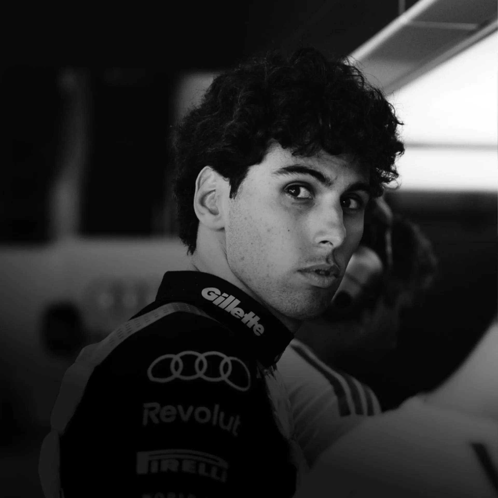 Black and white shot of Gabriel Bortoleto inside the garage