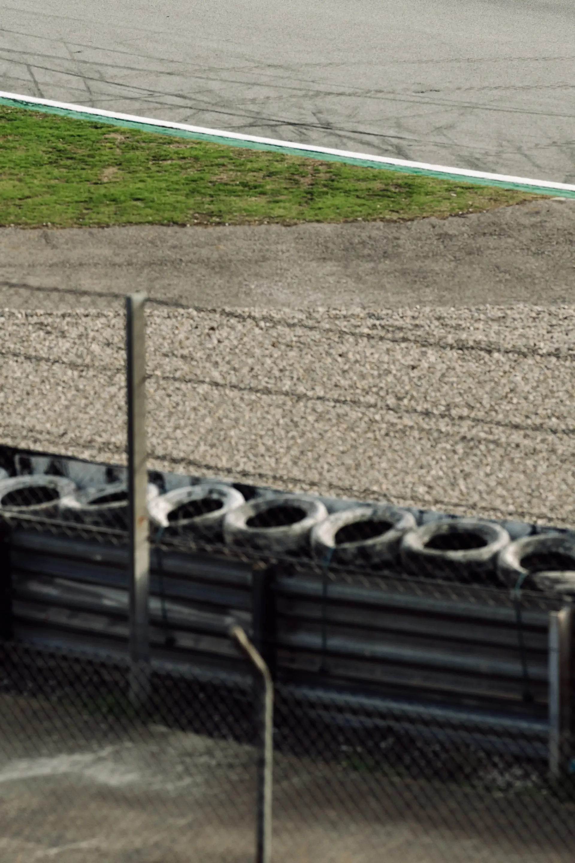 Trackside barriers and fencing overlooking a corner of the Spa-Francorchamps circuit.