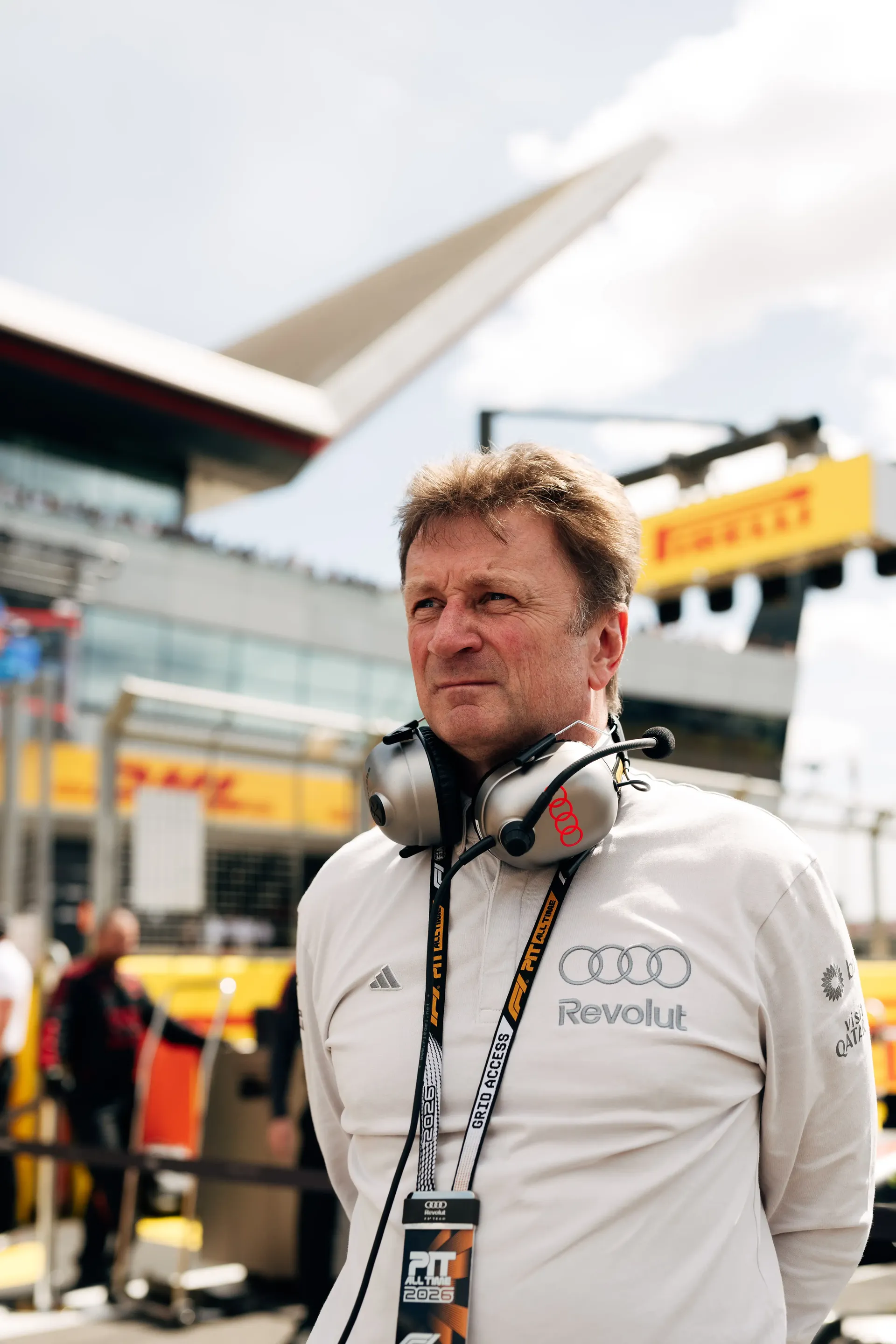 Allan McNish racing director at the Audi Revolut F1® Team observing the race wearing adidas teamwear
