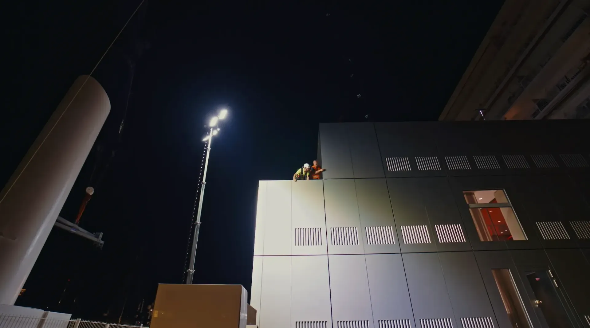 Audi Revolut F1® Team truck under stadium lights approaching Barcelona circuit