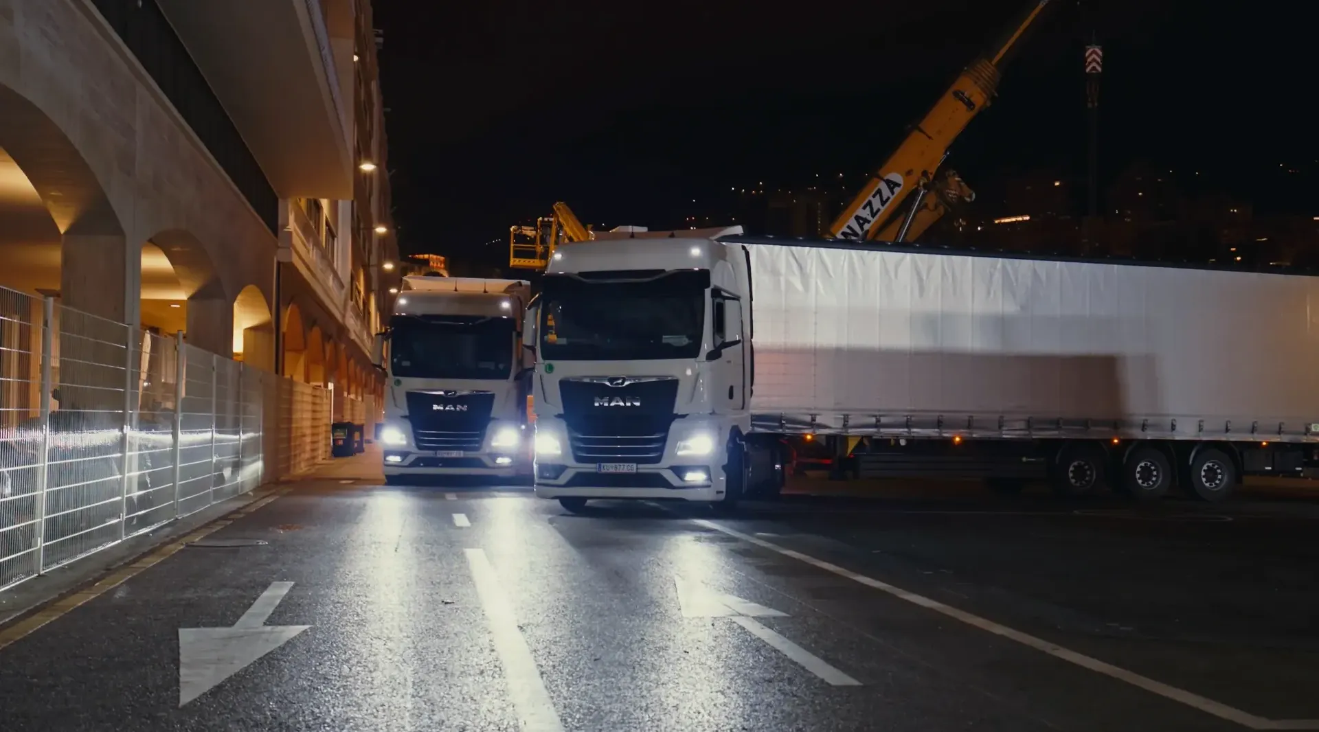 Audi Revolut F1® Team transport fleet parked roadside with reflections on wet asphalt