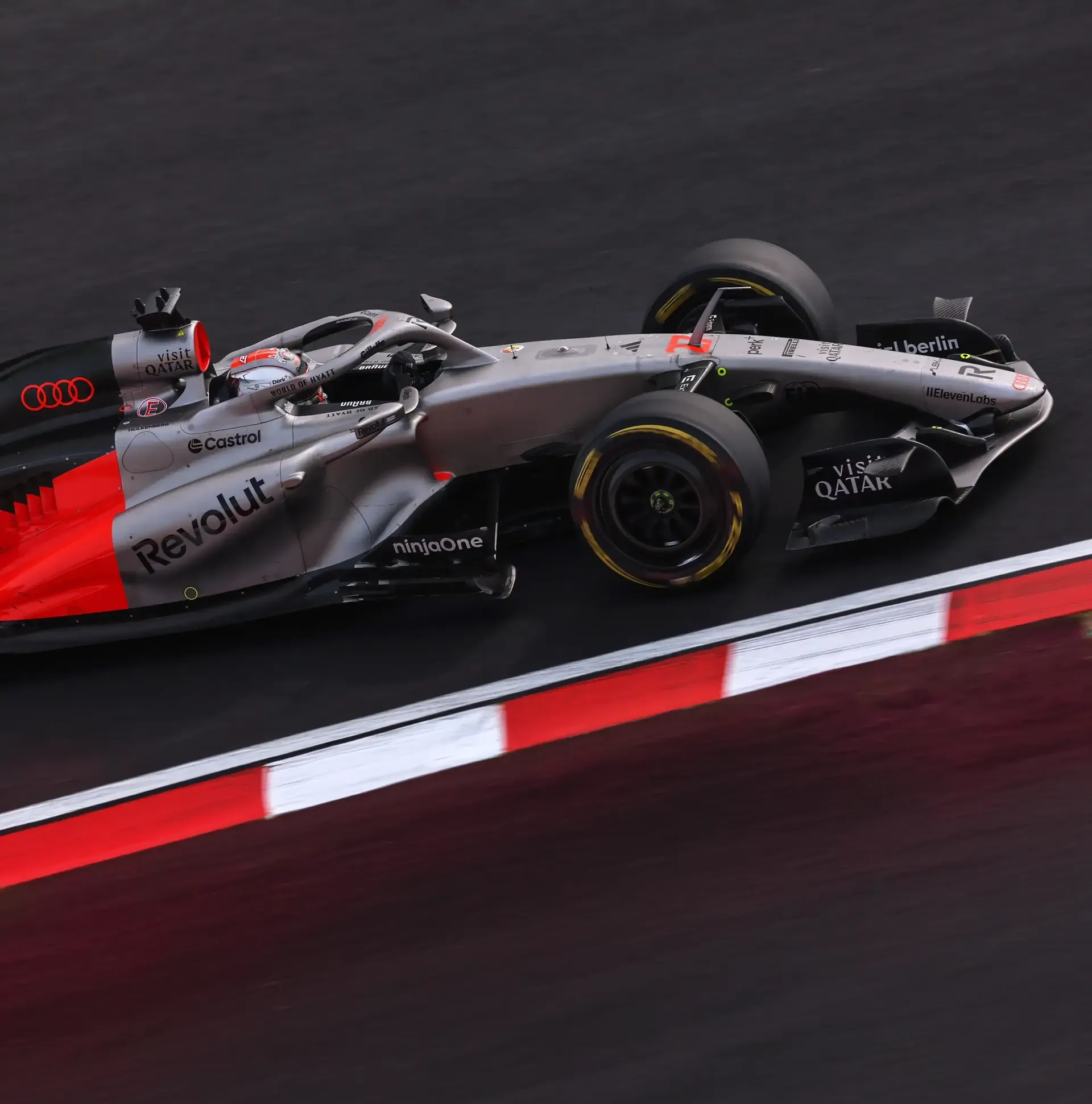 Side view of the Audi Revolut F1® Team car on the racing track passing by at high speed