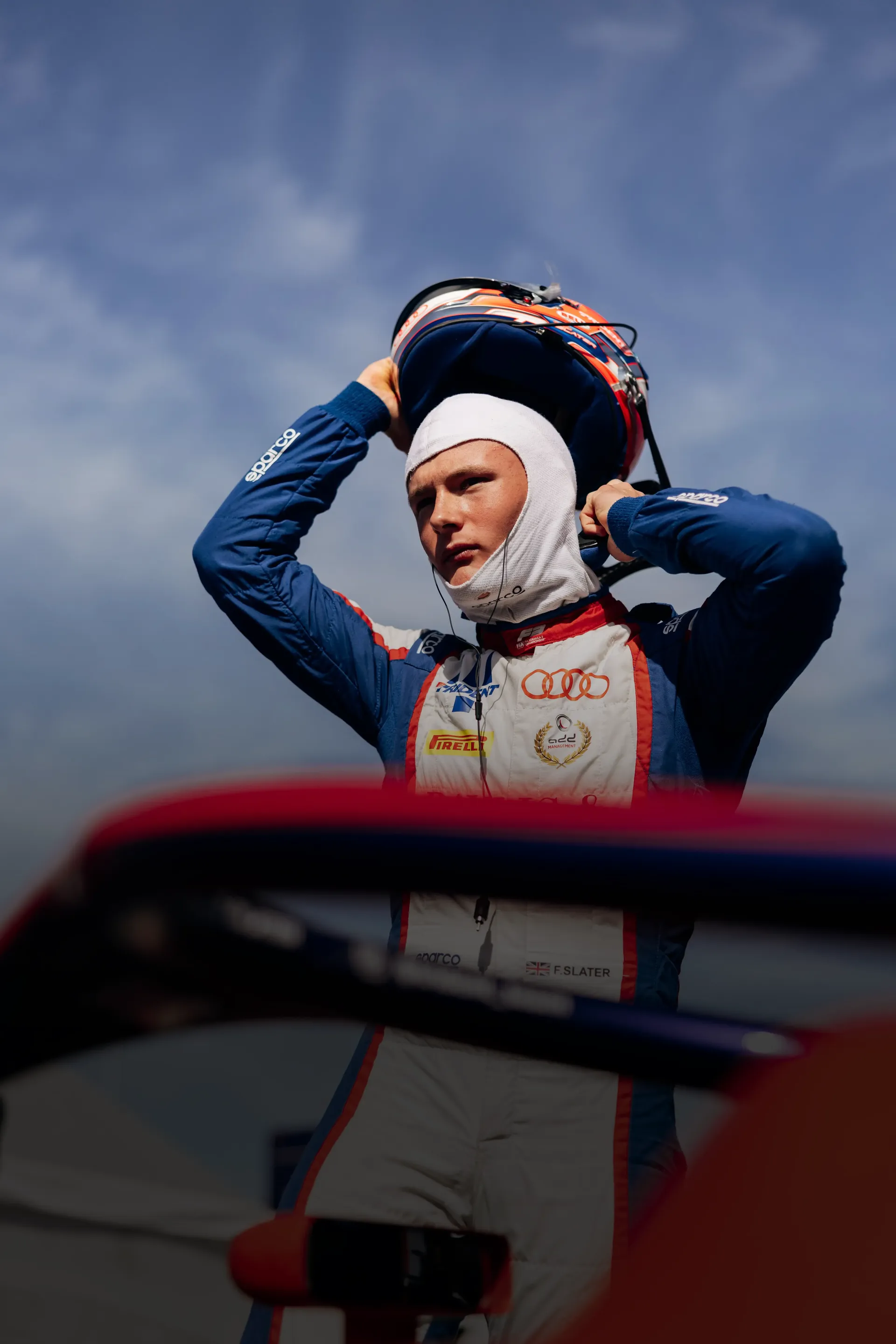 Audi Revolut F1® Team Academy driver Freddie Slater adjusts his helmet before heading out for an FIA Formula 3 session at the Hungaroring.