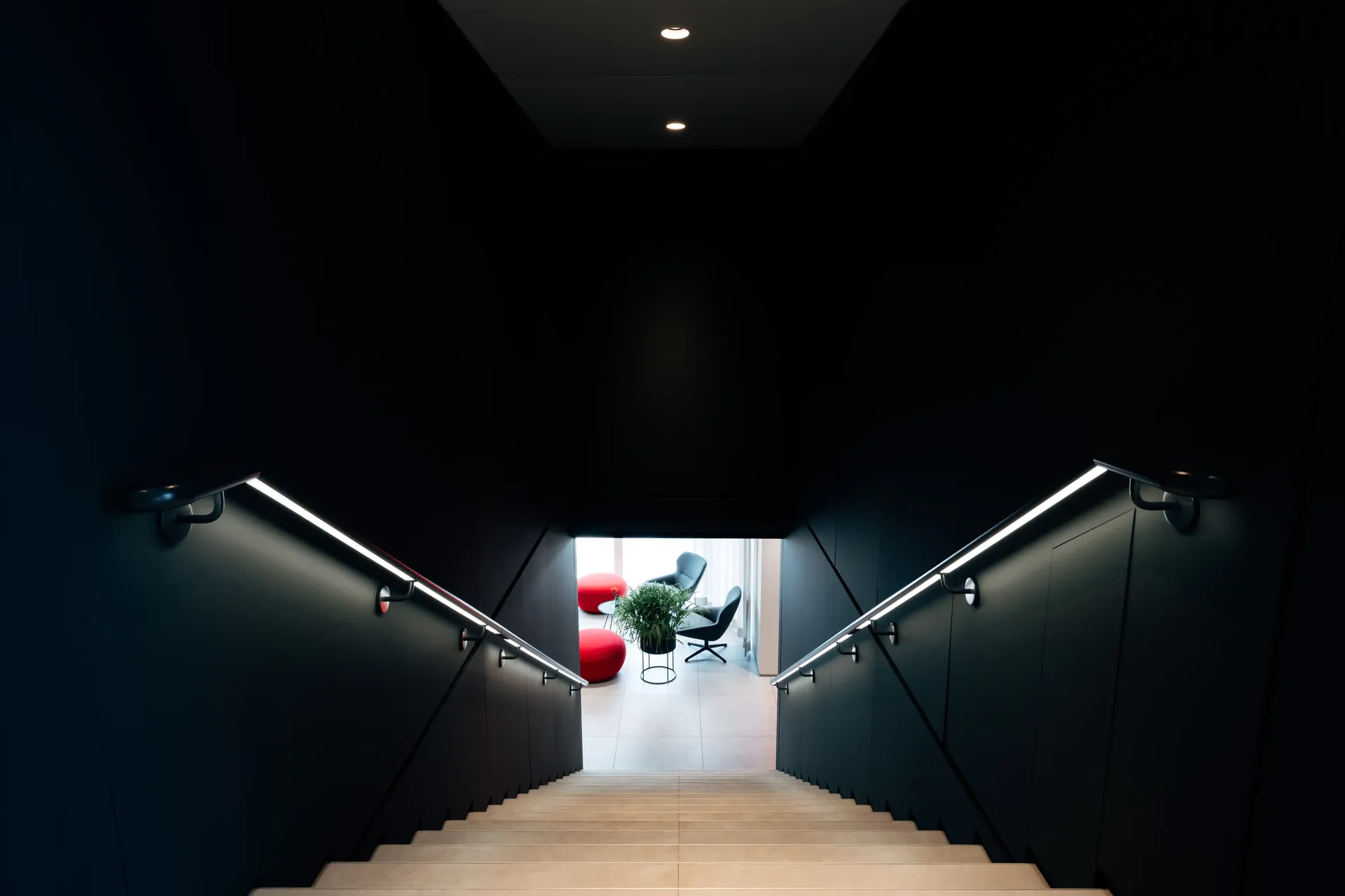 Dramatic interior corridor of the Audi Revolut F1® Team hospitality hub with illuminated ceiling lighting.