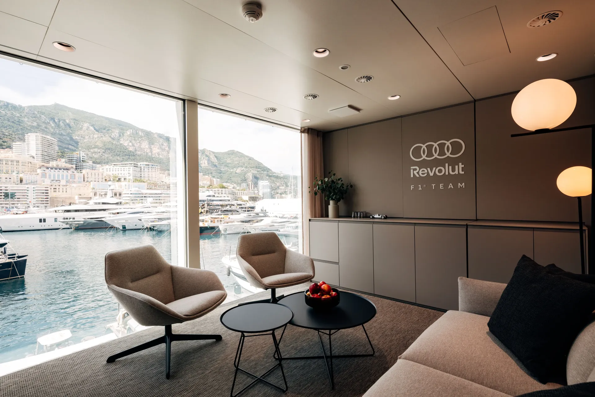 Lounge seating area inside the Audi Revolut F1® Team hospitality hub overlooking the paddock.