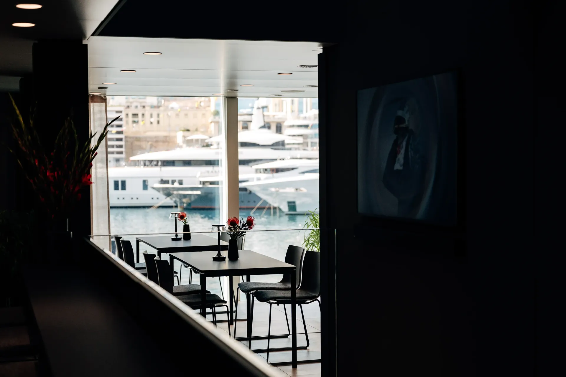 Hospitality hub entrance or reception area with views toward the Formula 1 paddock.