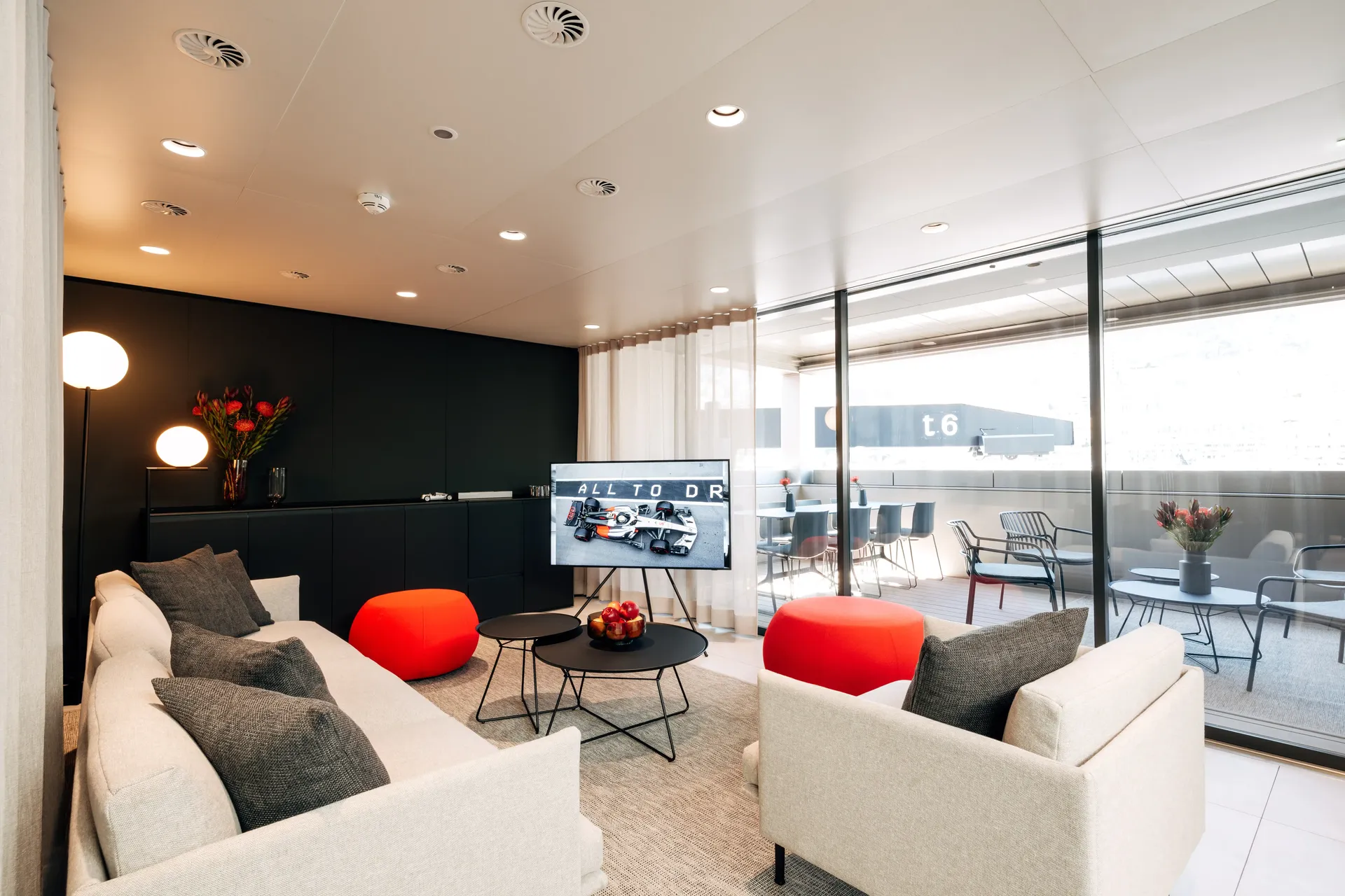 Contemporary dining and lounge area inside the Audi Revolut F1® Team hospitality hub.
