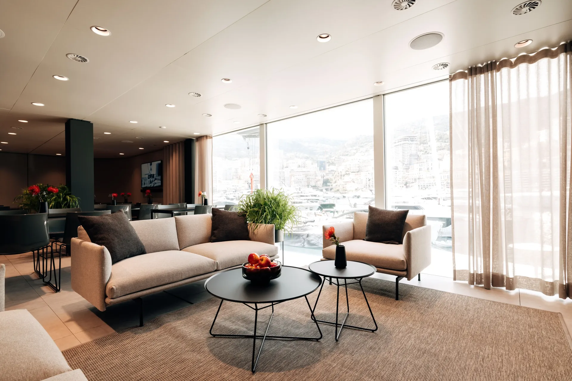 Open-plan lounge area inside the Audi Revolut F1® Team hospitality hub with modern furnishings.