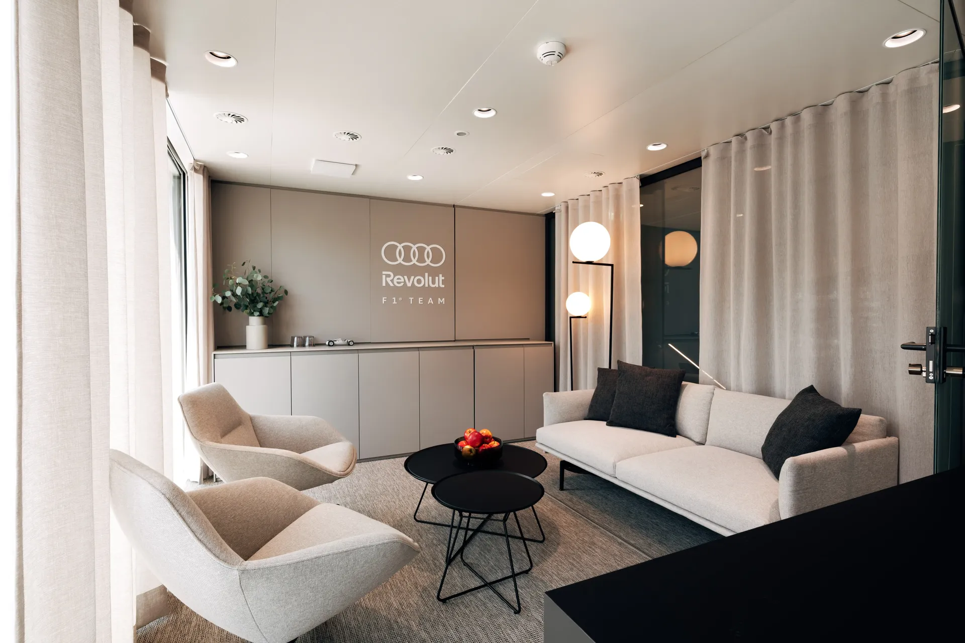 Premium lounge space inside the Audi Revolut F1® Team hospitality hub with contemporary seating.