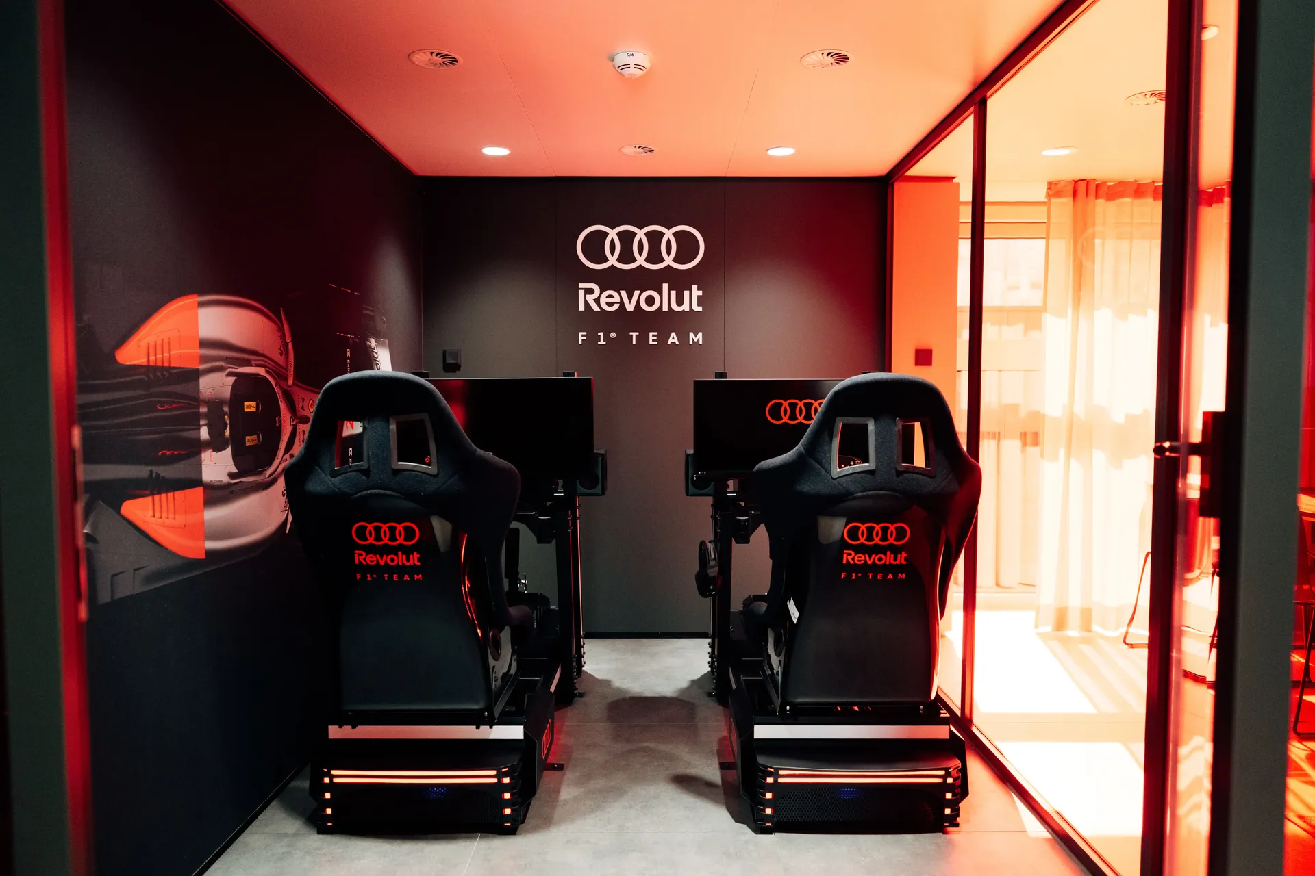 Audi Revolut F1® Team simulator and fan engagement area inside the hospitality hub.