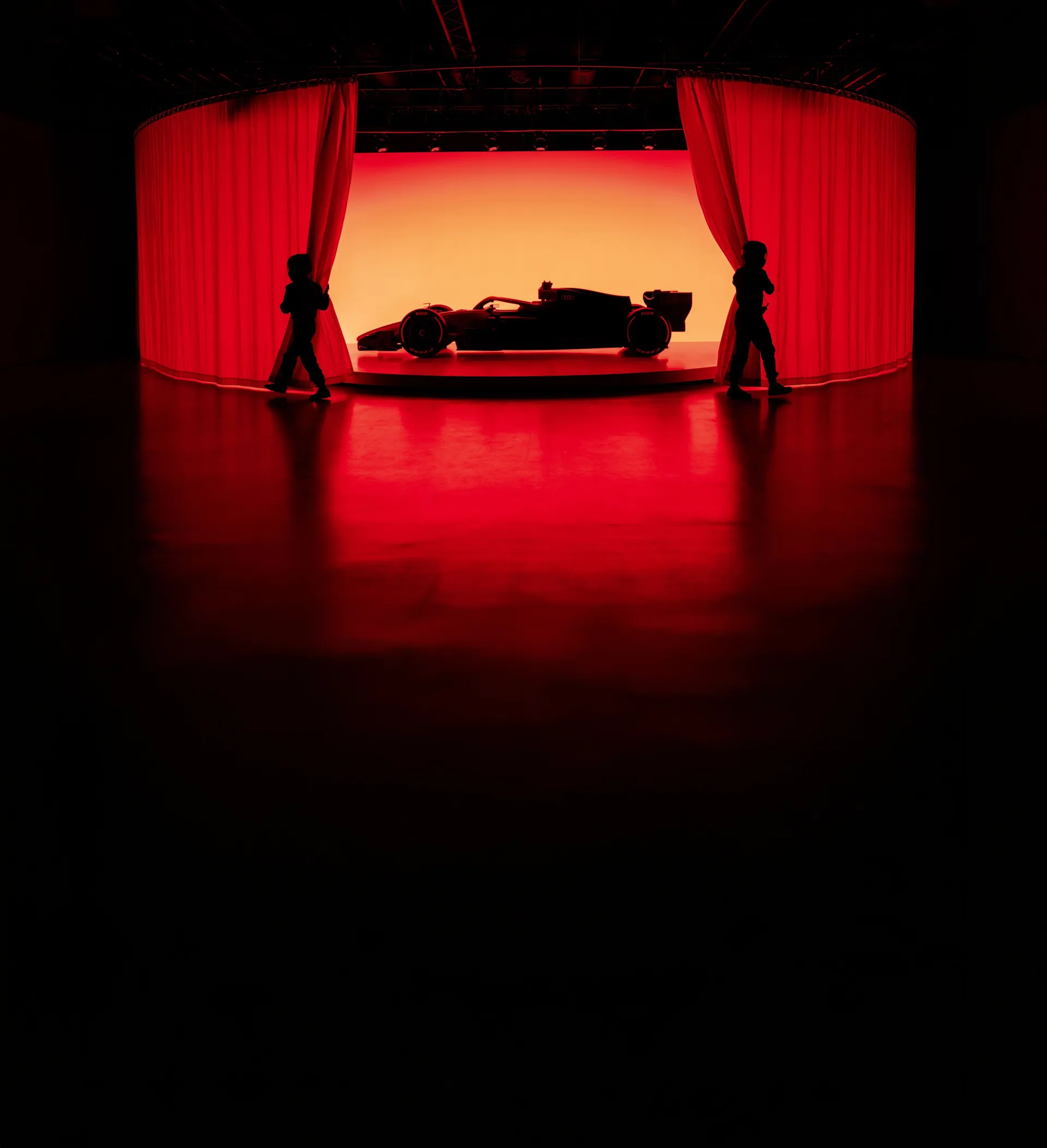 Sideview of the Audi R26 in dramatic red light car show reveal
