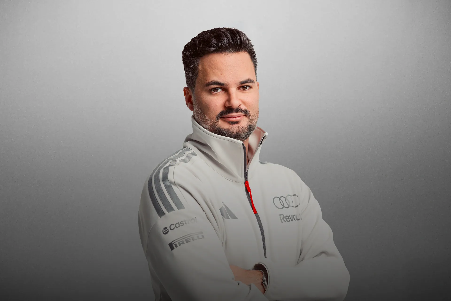 Chief Commercial Officer Audi Revolut F1® Team in the Studio wearing white Engineerwear with Audi and adidas Logos