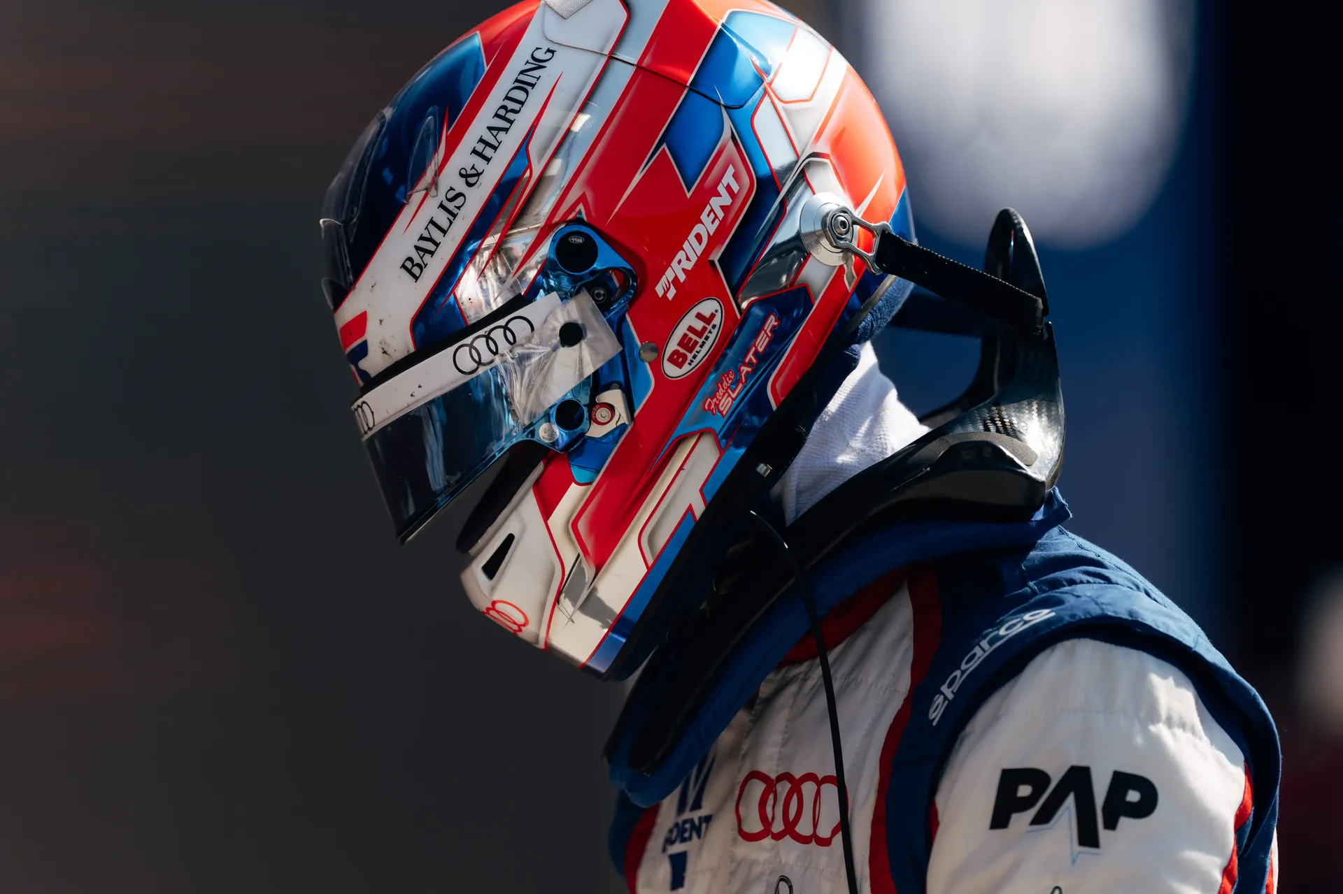 Formula 3 driver Freddie Slater wearing his racing helmet and Audi race suit before going on track.