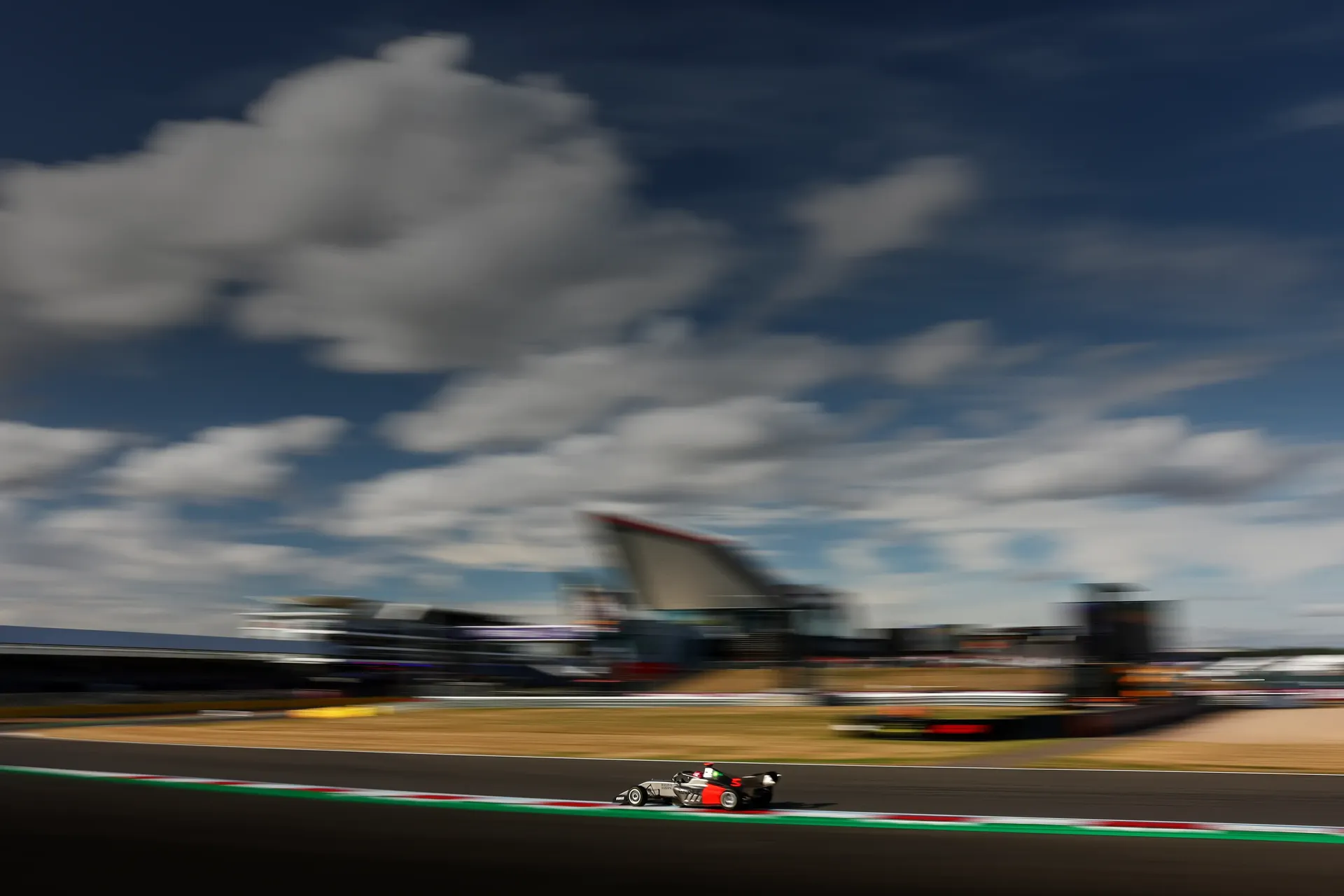 Side view of Emma Felbermayr driver at the Audi Revolut F1® Team Academy passing by at high speed the British Grand Prix 2026 in Silverstone