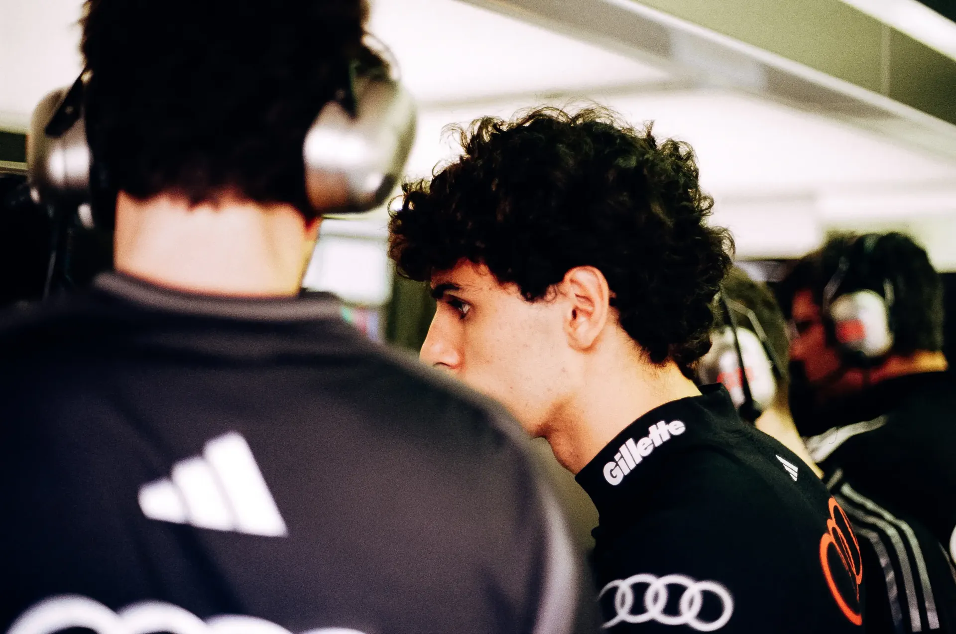 Audi Revolut F1® Team driver Gabriel Bortoleto speaks with an engineer inside the team garage before the session.