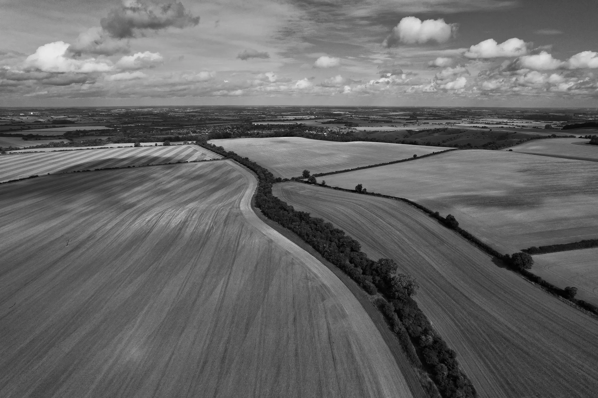 Aerial black-and-white view of the rural landscape surrounding Silverstone Circuit.