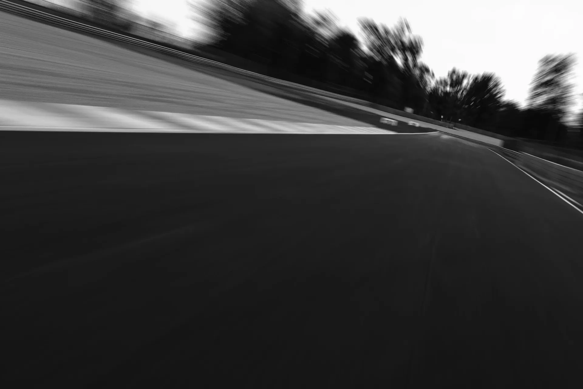 Motion-blurred view through a fast corner at Silverstone Circuit.