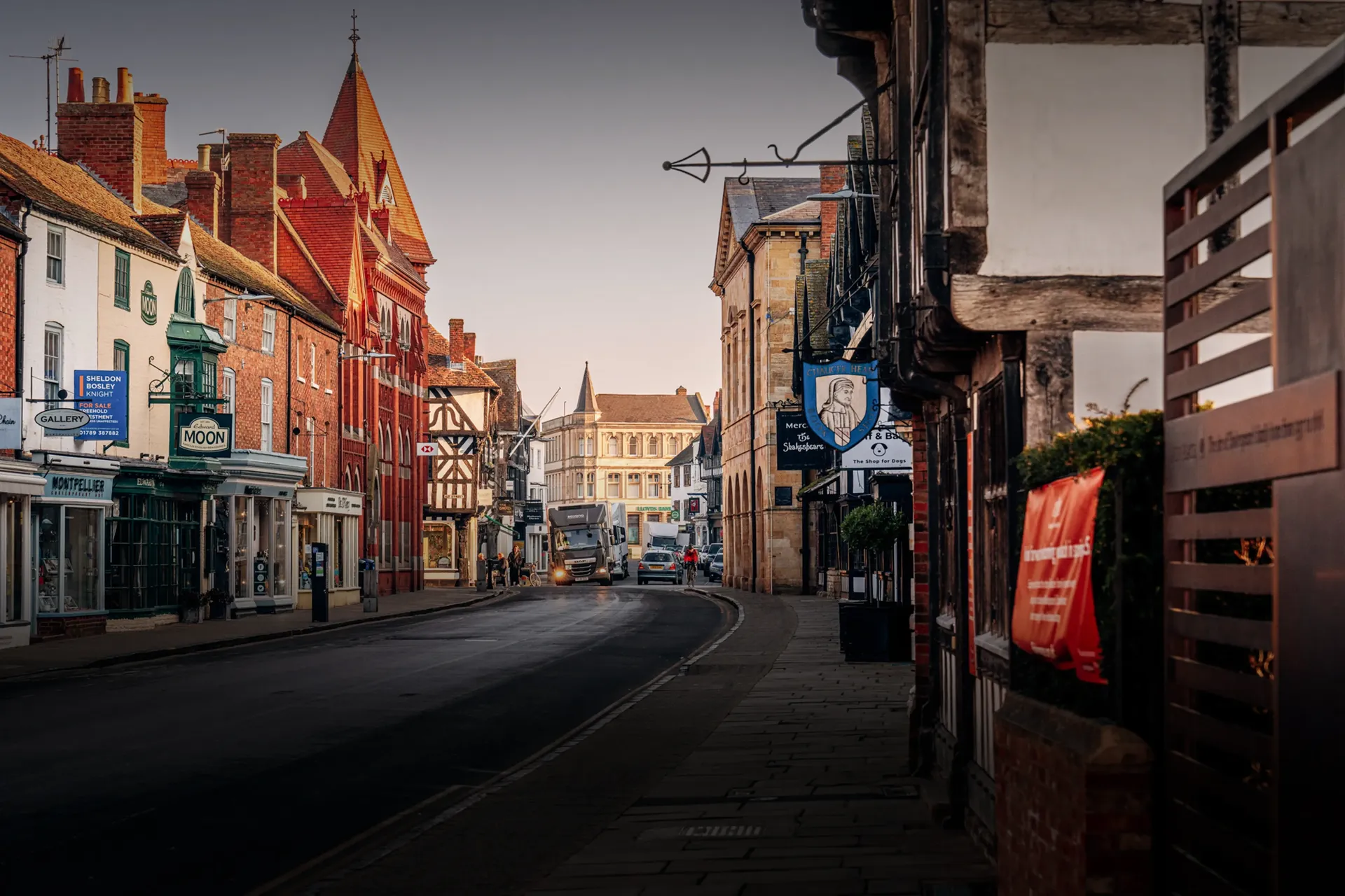 Quiet village high street with traditional buildings near Silverstone.