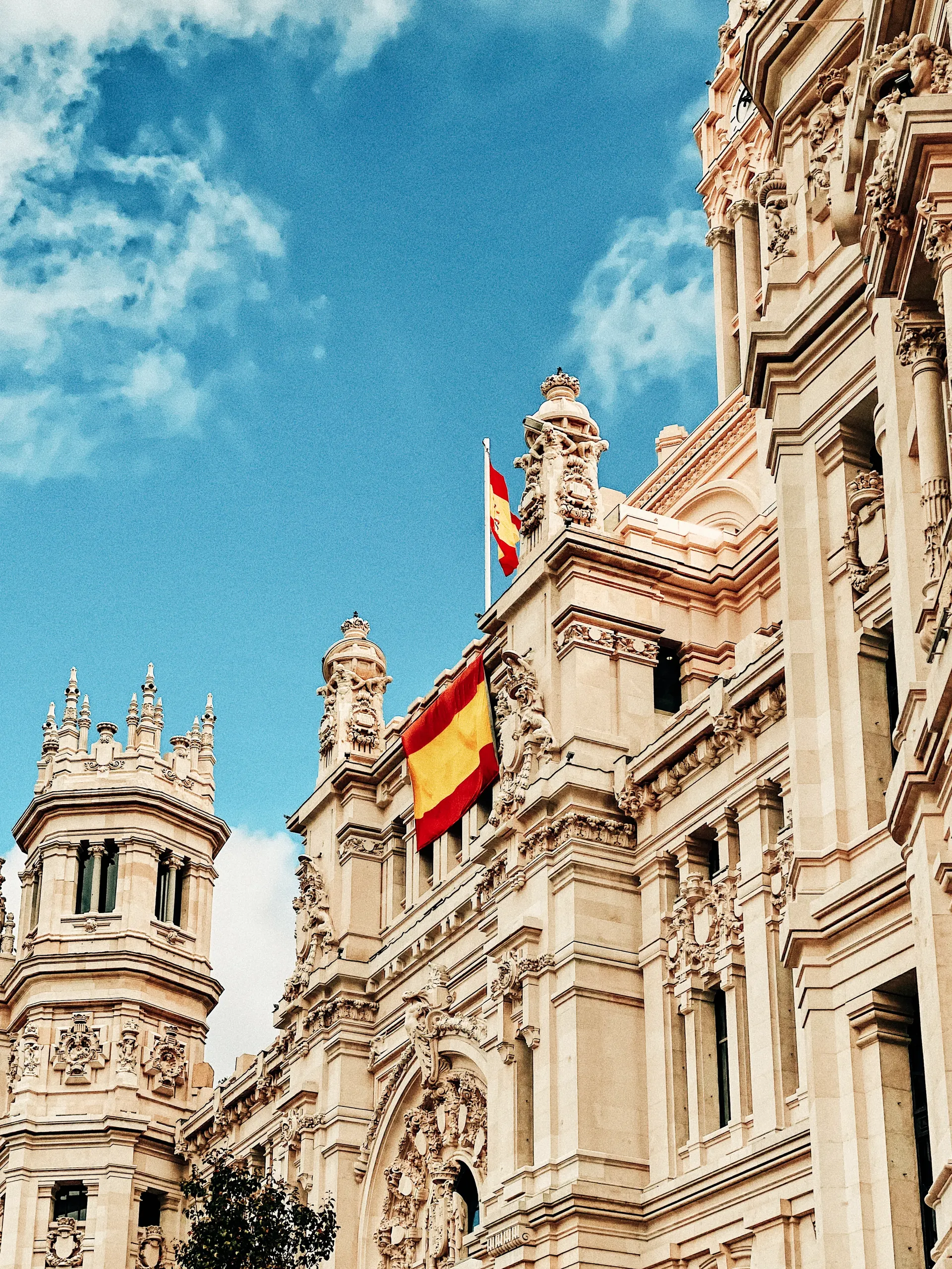 Madrid city architecture with a Spanish flag